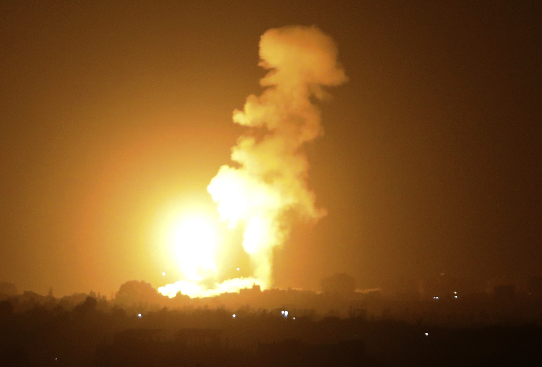A fireball rises following an air strike in Khan Yunis in the southern Gaza Strip, late on September 6, 2021. (Photo by SAID KHATIB / AFP)