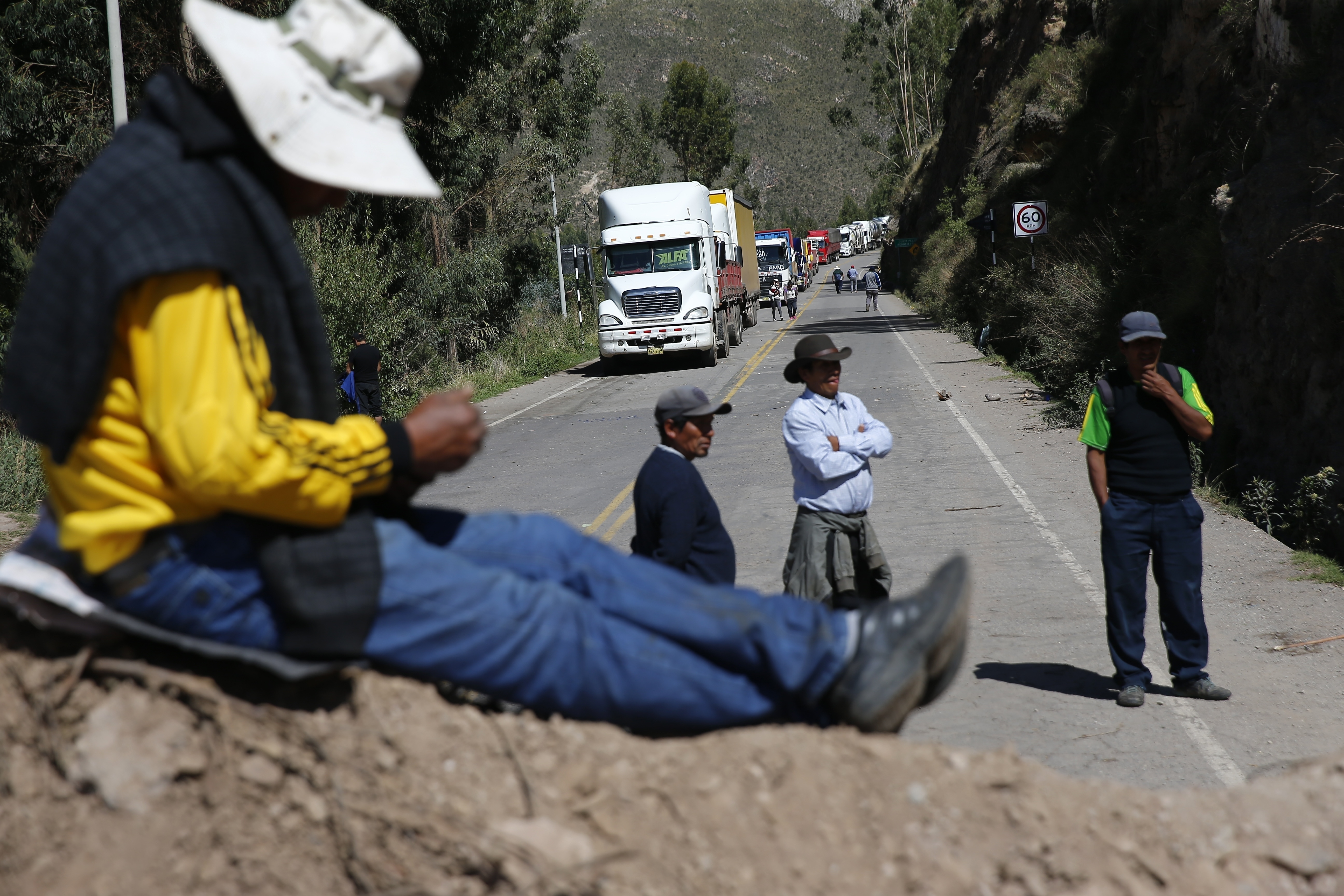 Anti-government protesters block the Pan-American highway in Cusco, Peru, Friday, January 13, 2023. The protesters demand an immediate electoral advance, the resignation of Boluarte, the release of impeached President Pedro Castillo, and justice for the 48 protesters killed in clashes. with the police.  (AP Photo/Hugo Curotto)