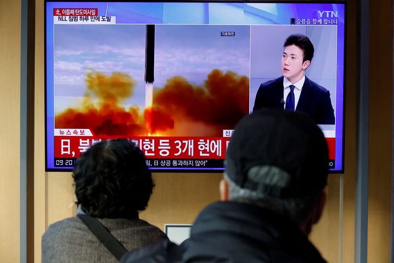 People watch a TV broadcasting a news about North Korea launching a ballistic missile off its eastern coast, in Seoul, South Korea, November 3, 2022. REUTERS/Heo Ran