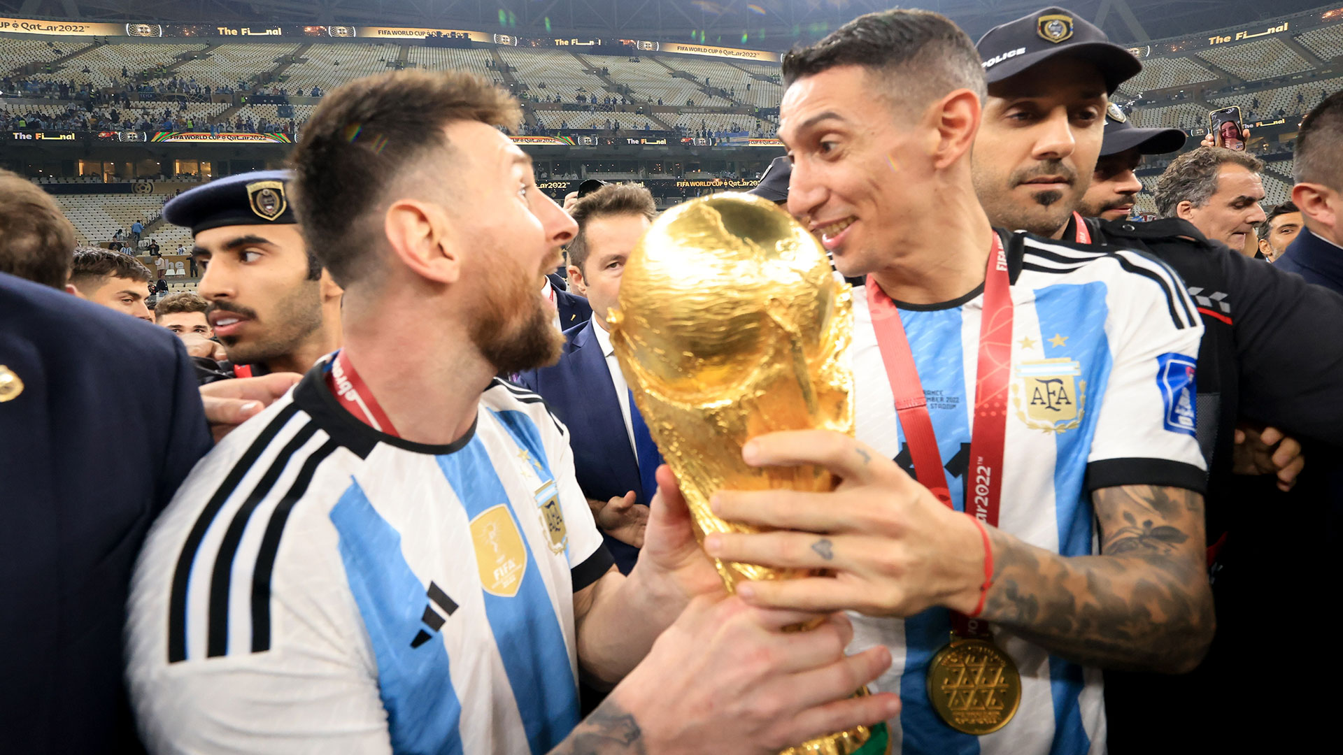 LUSAIL CITY, QATAR - DECEMBER 18: Lionel Messi and Ángel Di María of Argentina hold the FIFA World Cup Qatar 2022 Winner's Trophy after winning the FIFA World Cup Qatar 2022 Final match between Argentina and France at Lusail Stadium on December 18, 2022 in Lusail City, Qatar. (Photo by Gustavo Pagano/Getty Images)