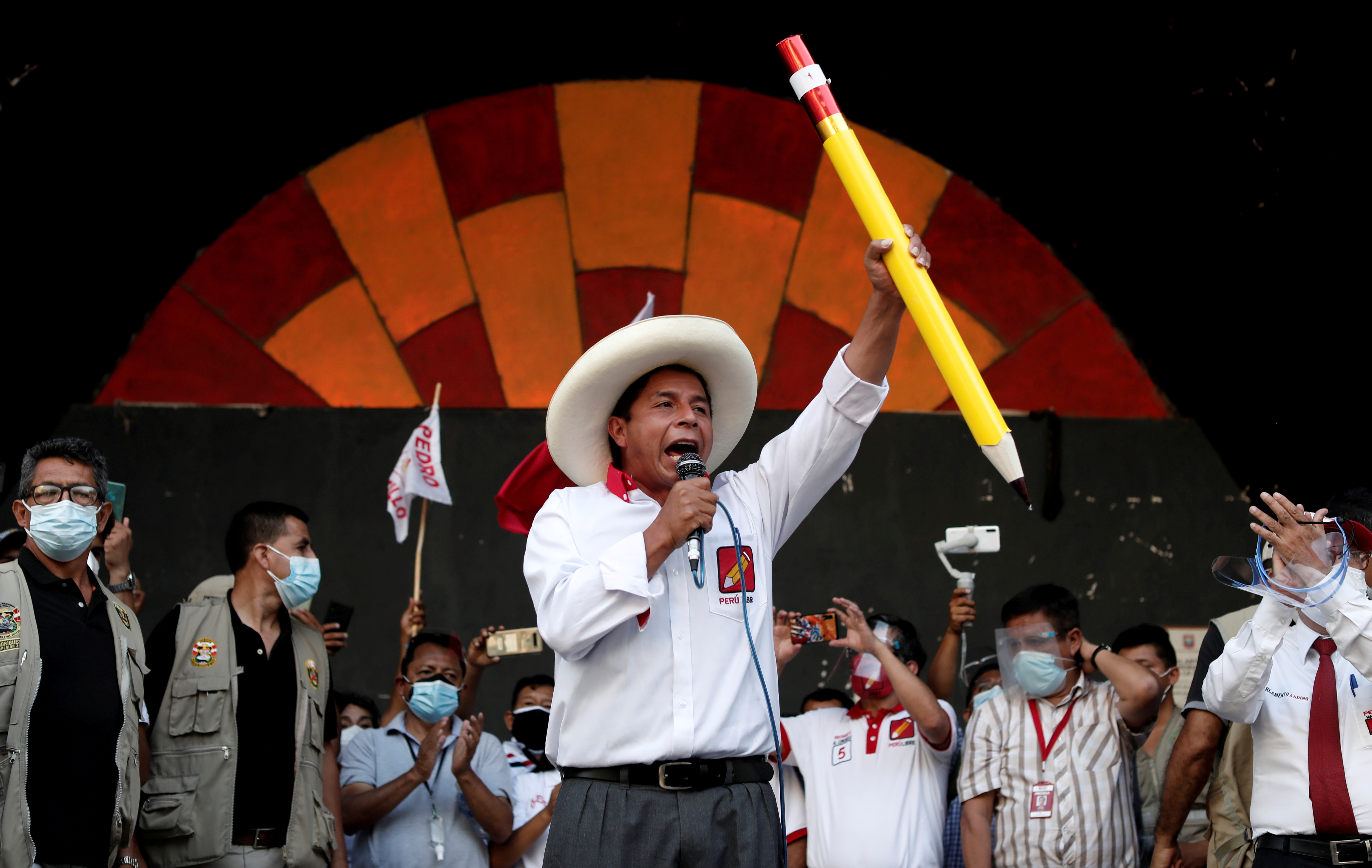 FILE PHOTO: Peru's presidential candidate Pedro Castillo of Peru Libre party, who will compete head-to-head with right-wing candidate Keiko Fujimori in a second-round ballot in June, speaks to supporters during a rally in Lima, Peru/File Photo