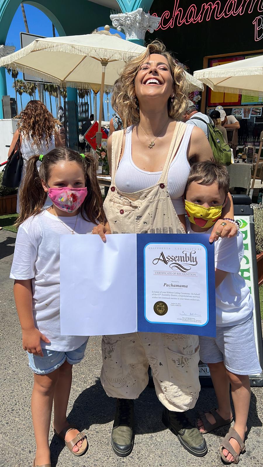 Victoria Vannucci with her children Indiana and Napoleon and certificate for the inauguration of Pachamama