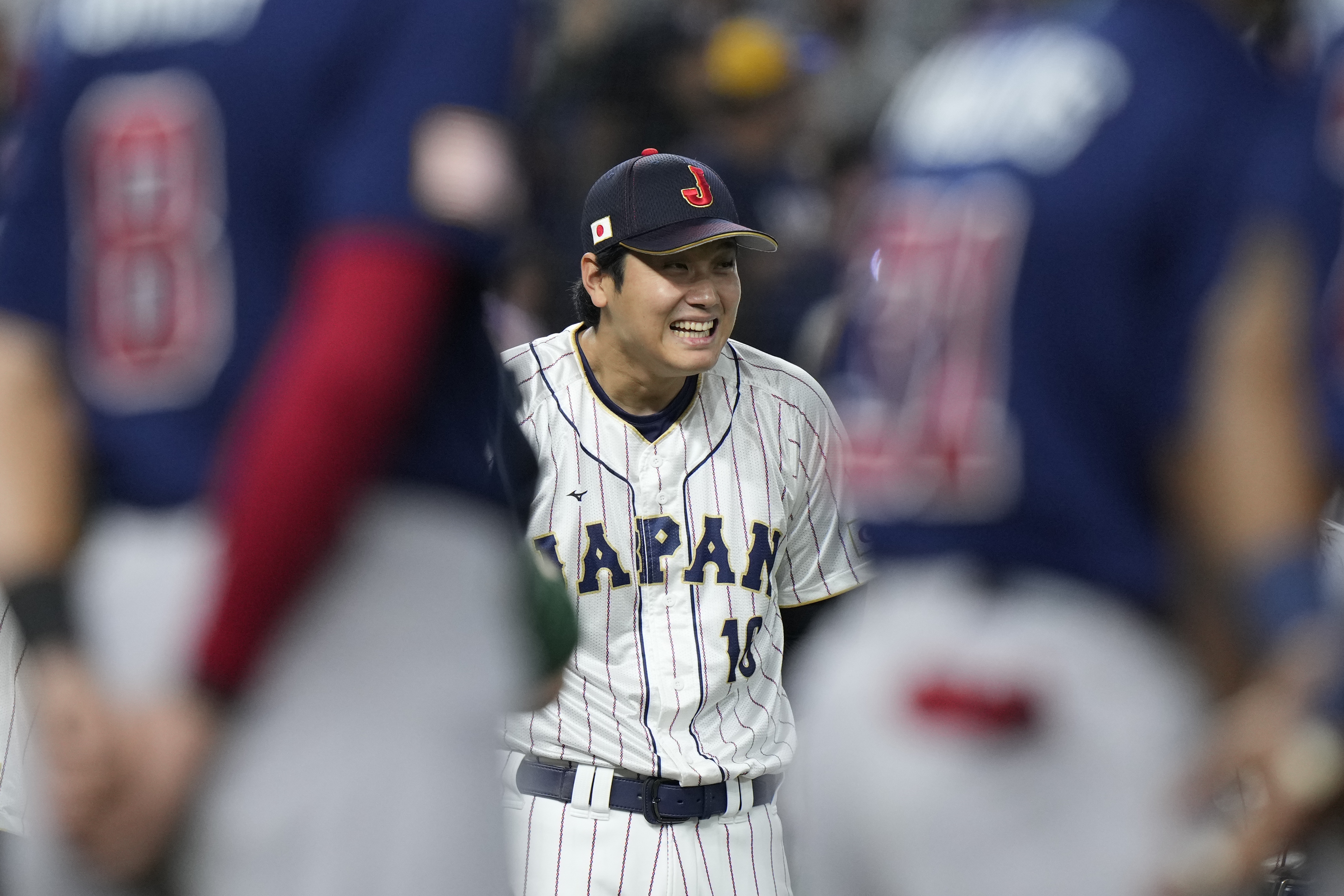 Japan's Shohei Ohtani (16) smiles as he introduces the players before the final against the United States in the World Baseball Classic, Tuesday, March 21, 2023, in Miami.  (AP Photo/Wilfredo Lee)
