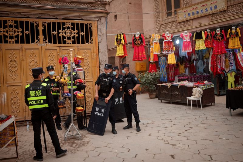 Police officers stand guard in the old city of Kashgar, Xinjiang region (Reuters).