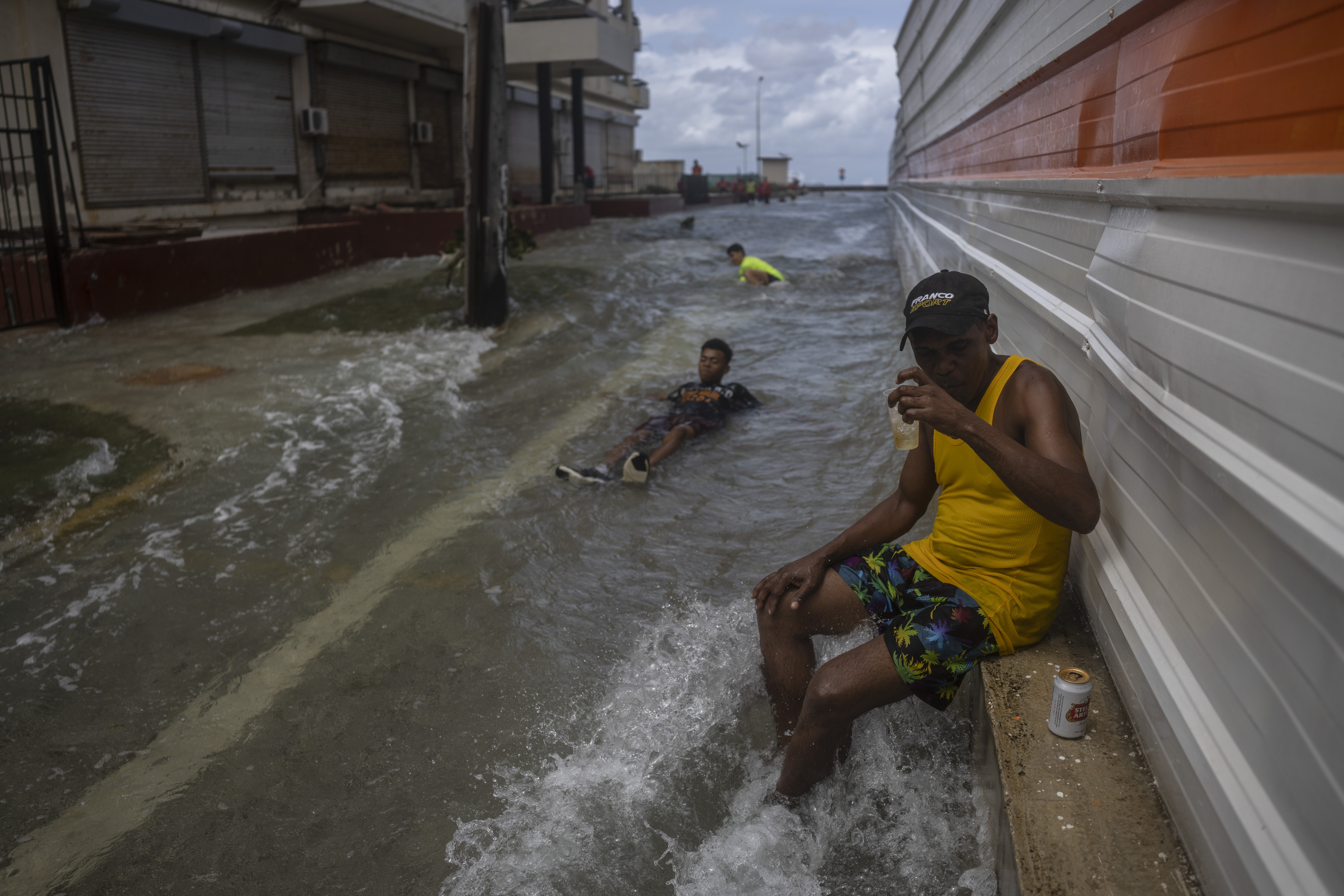 People play in a street flooded by the waves that break on the Malecon in the aftermath of Hurricane Ian in Havana, Cuba, Thursday, Sept. 29, 2022. (AP Photo/Ramon Espinosa)