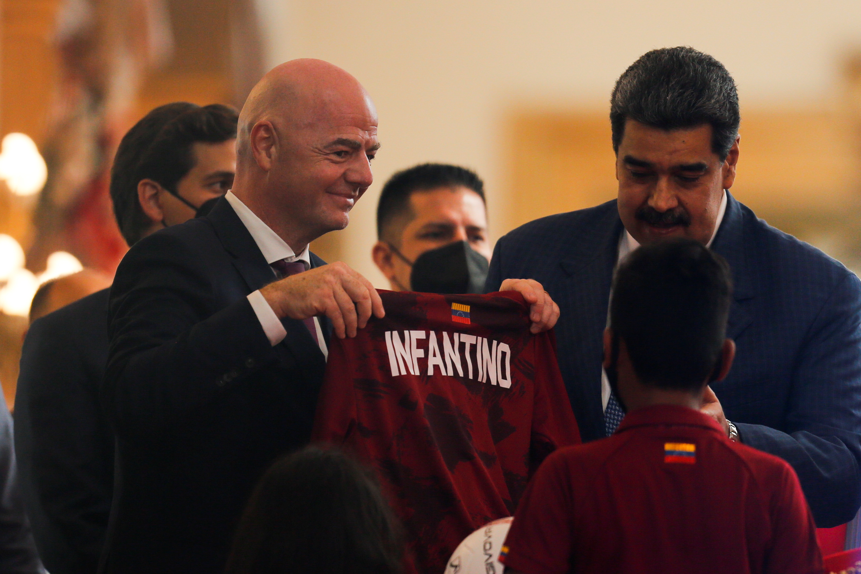 FIFA President Gianni Infantino is presented with a soccer jersey with his name next to Venezuela's President Nicolas Maduro at the Miraflores Palace during his visit in Caracas, Venezuela October 15, 2021. REUTERS/Leonardo Fernandez Viloria