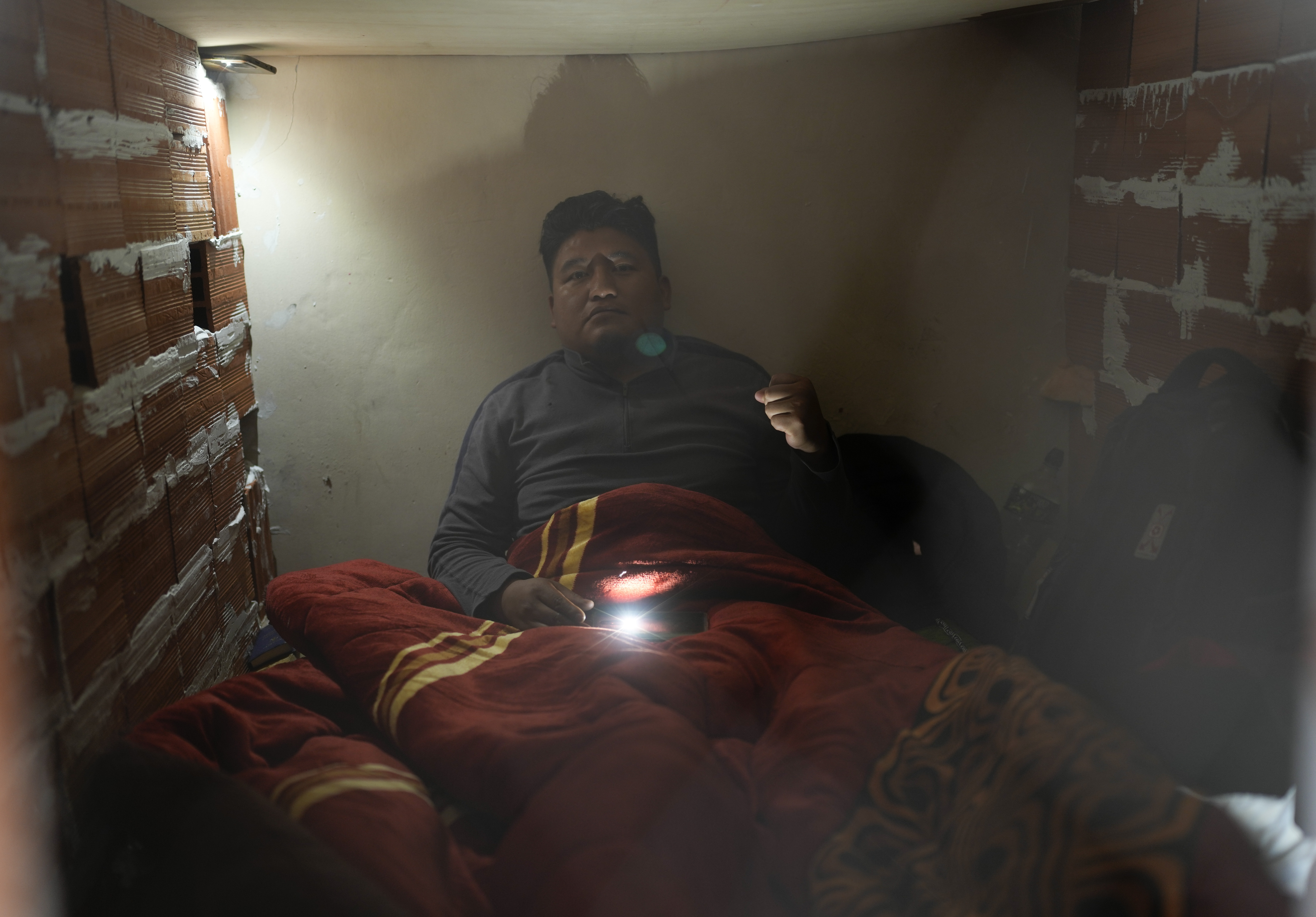 Wilfredo Ajllahuanca, inside the structure built by three educators on hunger strike who barricaded themselves inside the teachers' union headquarters, in La Paz, Bolivia, on May 2, 2023. The three leaders began the hunger strike on May 1 May after two months of protests by teachers demanding an increase in the budget for public education and a change in the new educational curriculum.  (AP Photo/Juan Karita)