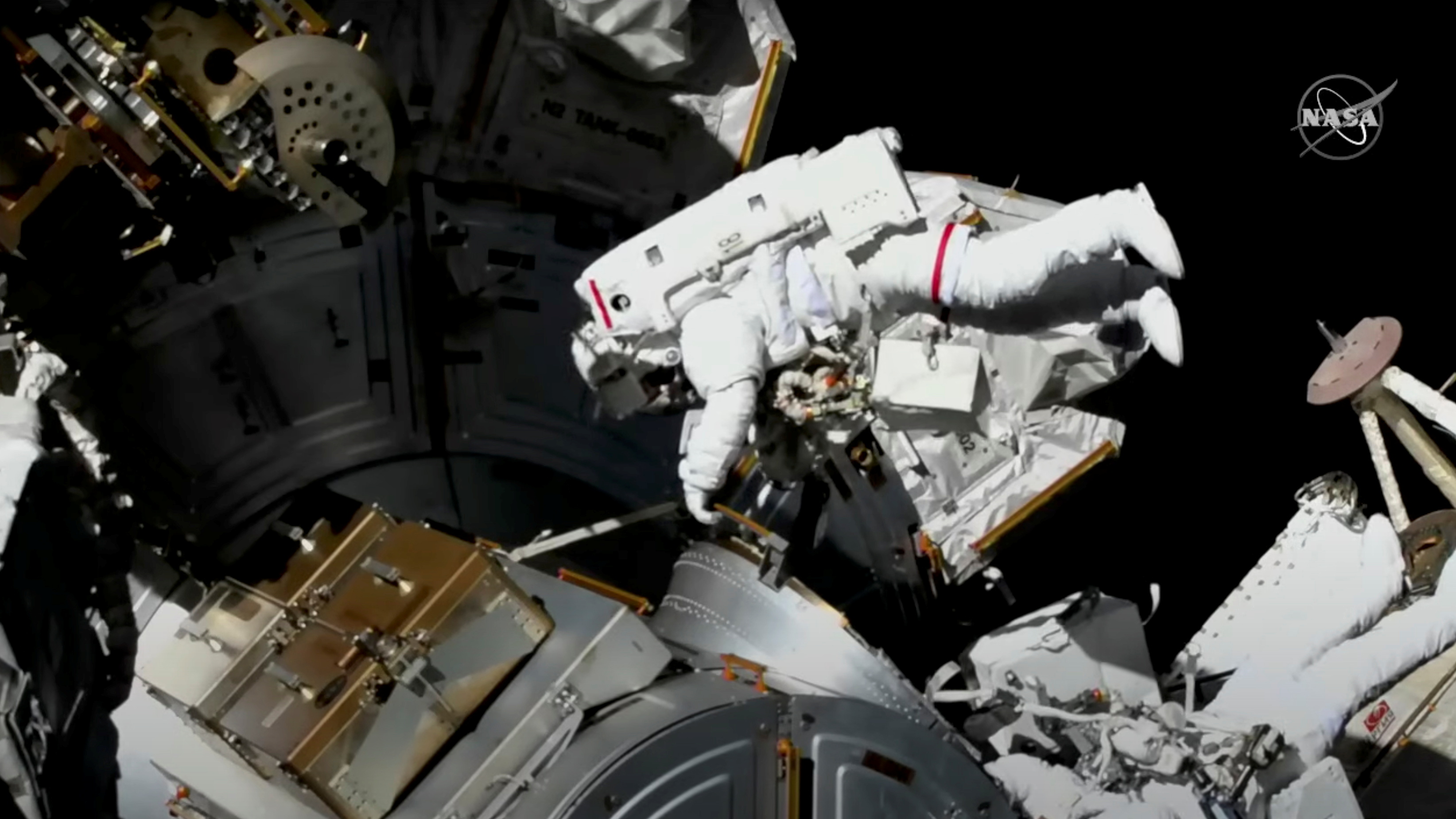 FILE PHOTO: Astronauts perform a spacewalk to replace a defective antenna on the International Space Station (ISS) in this December 2, 2021 photo (NASA TV/Reuters)