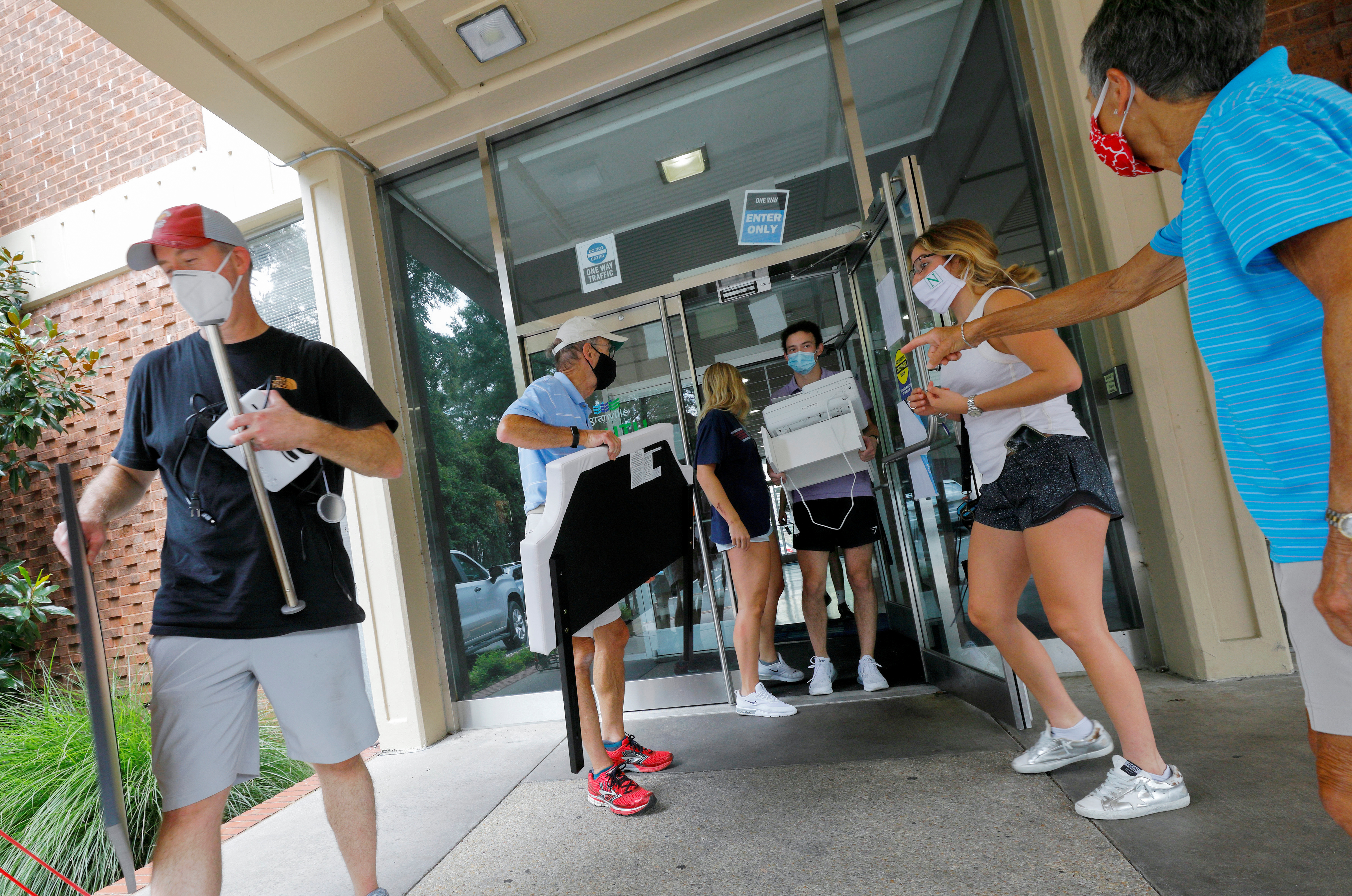 Family members assist students complying with a requirement by the University of North Carolina to move out of campus housing due to the coronavirus disease (COVID-19) outbreak in Chapel Hill, North Carolina, U.S. August 30, 2020. REUTERS/Jonathan Drake