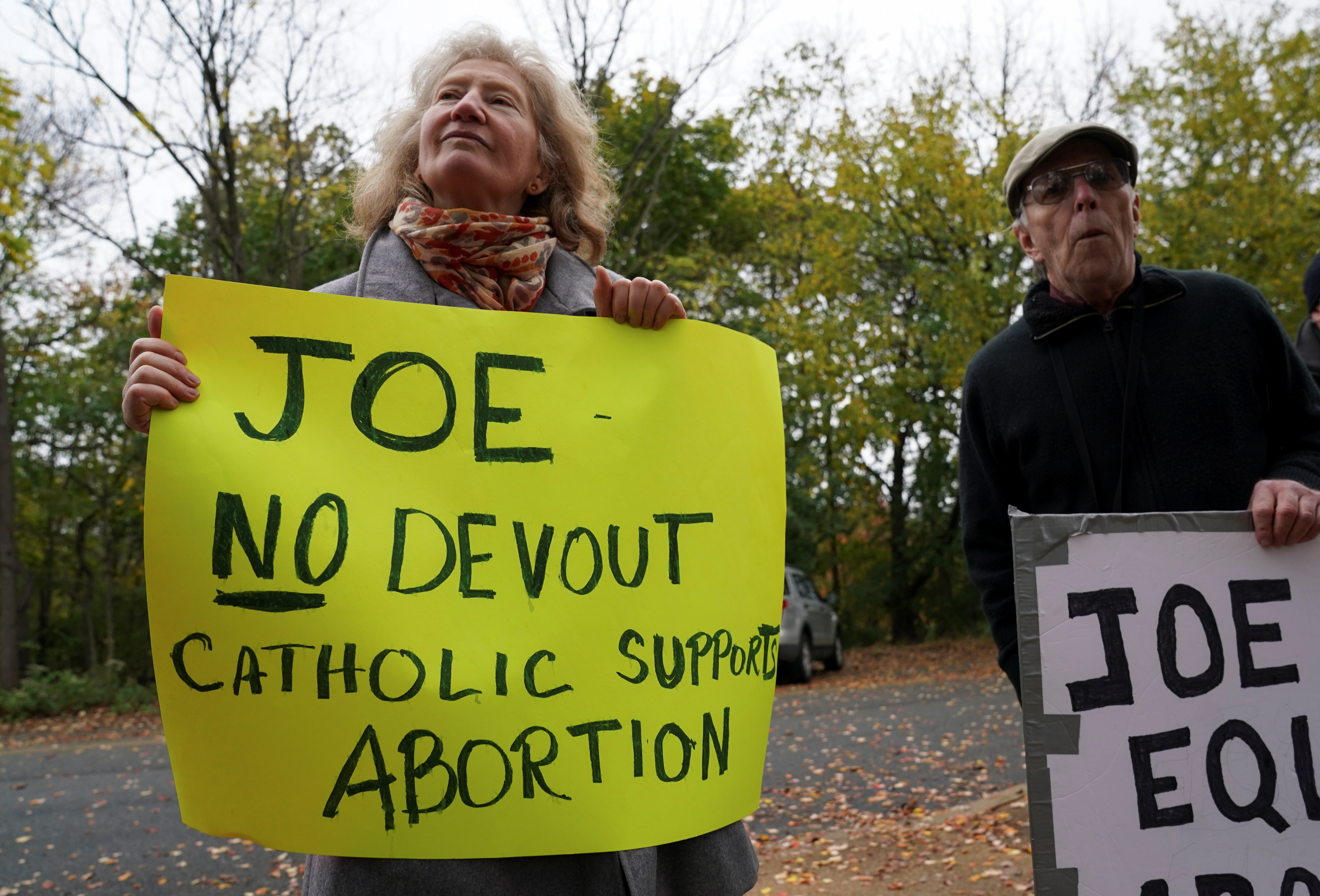 Una manifestante sostiene una pancarta con un mensaje anti aborto mientras Joe Biden asiste a una misa en Wilmington, Delaware. REUTERS/Kevin Lamarque