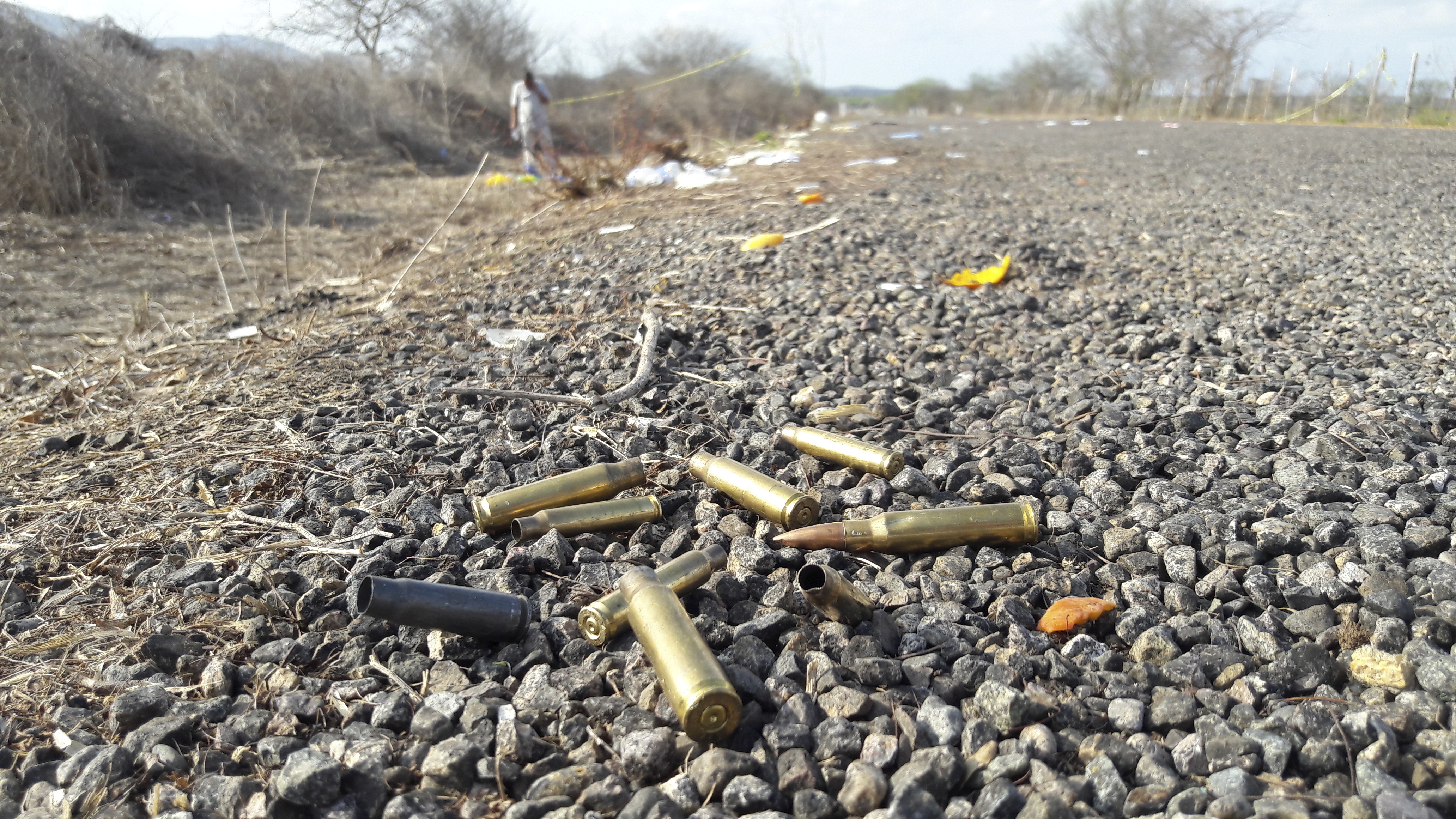FILE - Bullet casings litter the road after authorities report a gun battle between gunmen near the beach resort of Mazatlan, Mexico, Saturday, July 1, 2017. Mexican authorities reported that at least 19 People were killed in clashes between gunmen and security forces in gang-dominated territory to the northwest of Sinaloa, where homicides have spiked dramatically after the capture and extradition of convicted drug lord Joaquín "El Chapo" Guzman.  (AP Photo/Mario Rivera Alvarado, File)
