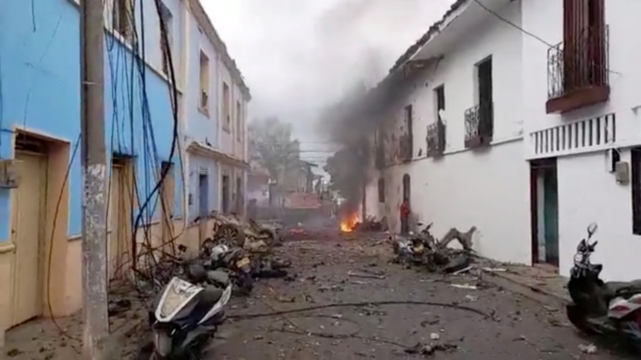 A fire, debris and damage to buildings can be seen in the aftermath of a blast outside the mayor?s office and city hall in Corinto, Cauca, Colombia, in this still frame taken from March 26, 2021 social media video.  NOTICORINTO PRODUCCIONES/via REUTERS THIS IMAGE HAS BEEN SUPPLIED BY A THIRD PARTY. MANDATORY CREDIT. NO RESALES. NO ARCHIVES.