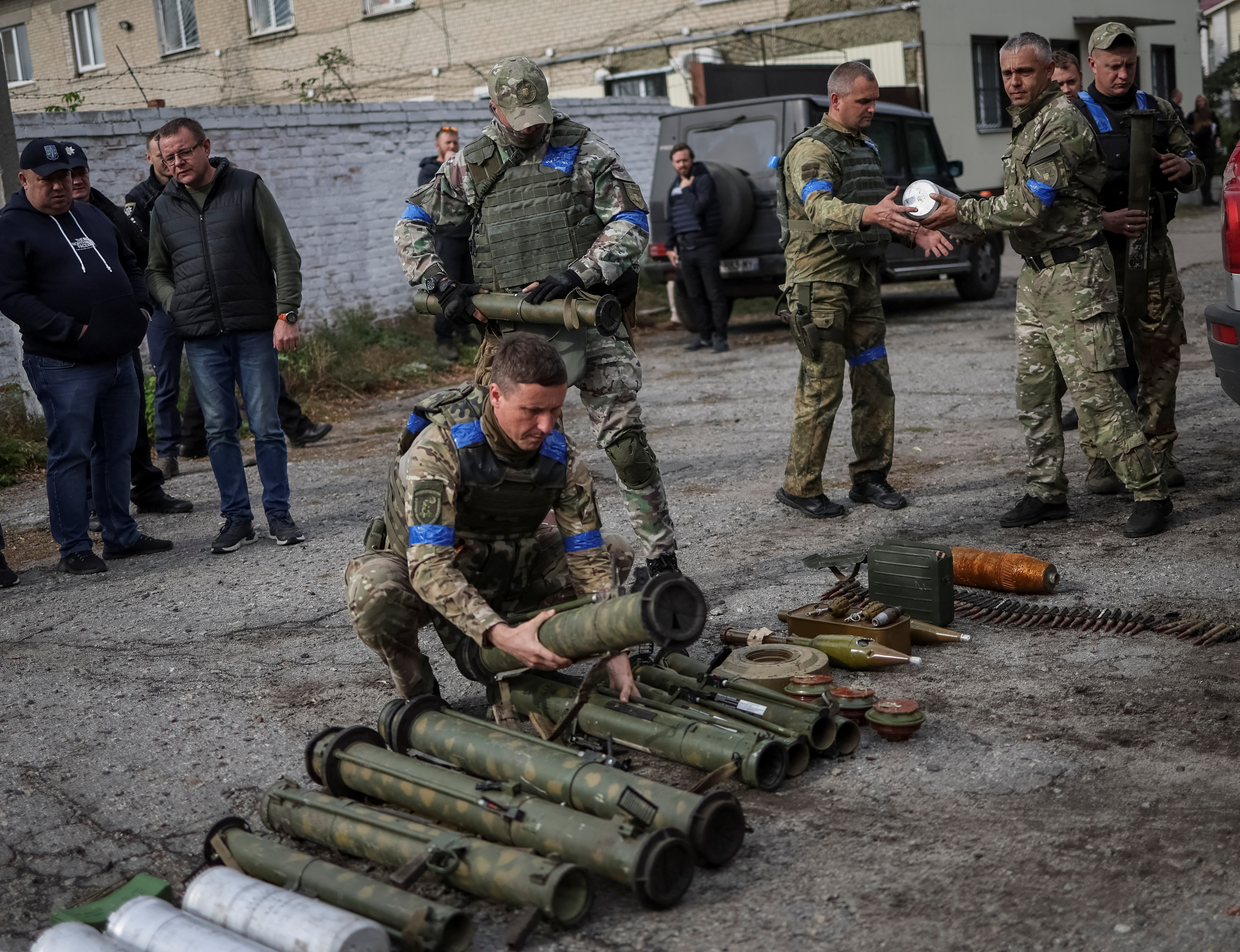 Un policía ucraniano ordena las municiones abandonadas por soldados rusos en Kharkiv (REUTERS/Gleb Garanich)