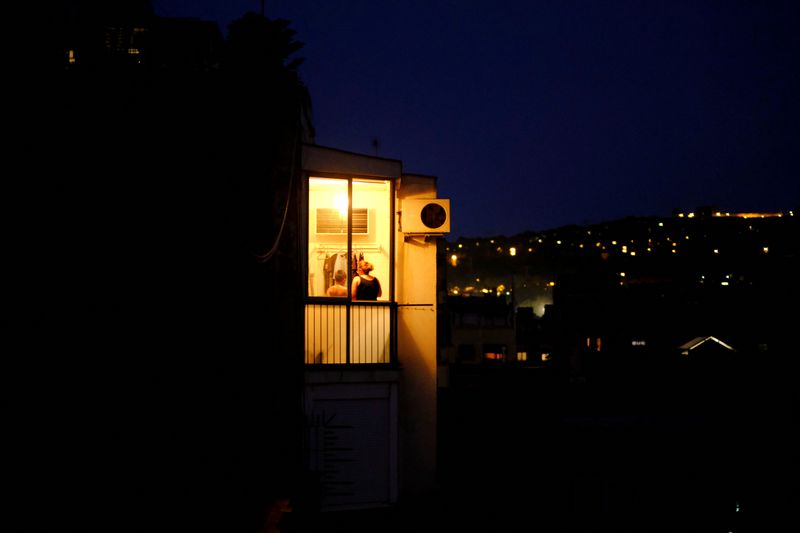 FOTO DE ARCHIVO: Un aparato de aire acondicionado junto a la ventana iluminada de una vivienda en Barcelona, España, el 14 de septiembre de 2021. REUTERS/Nacho Doce