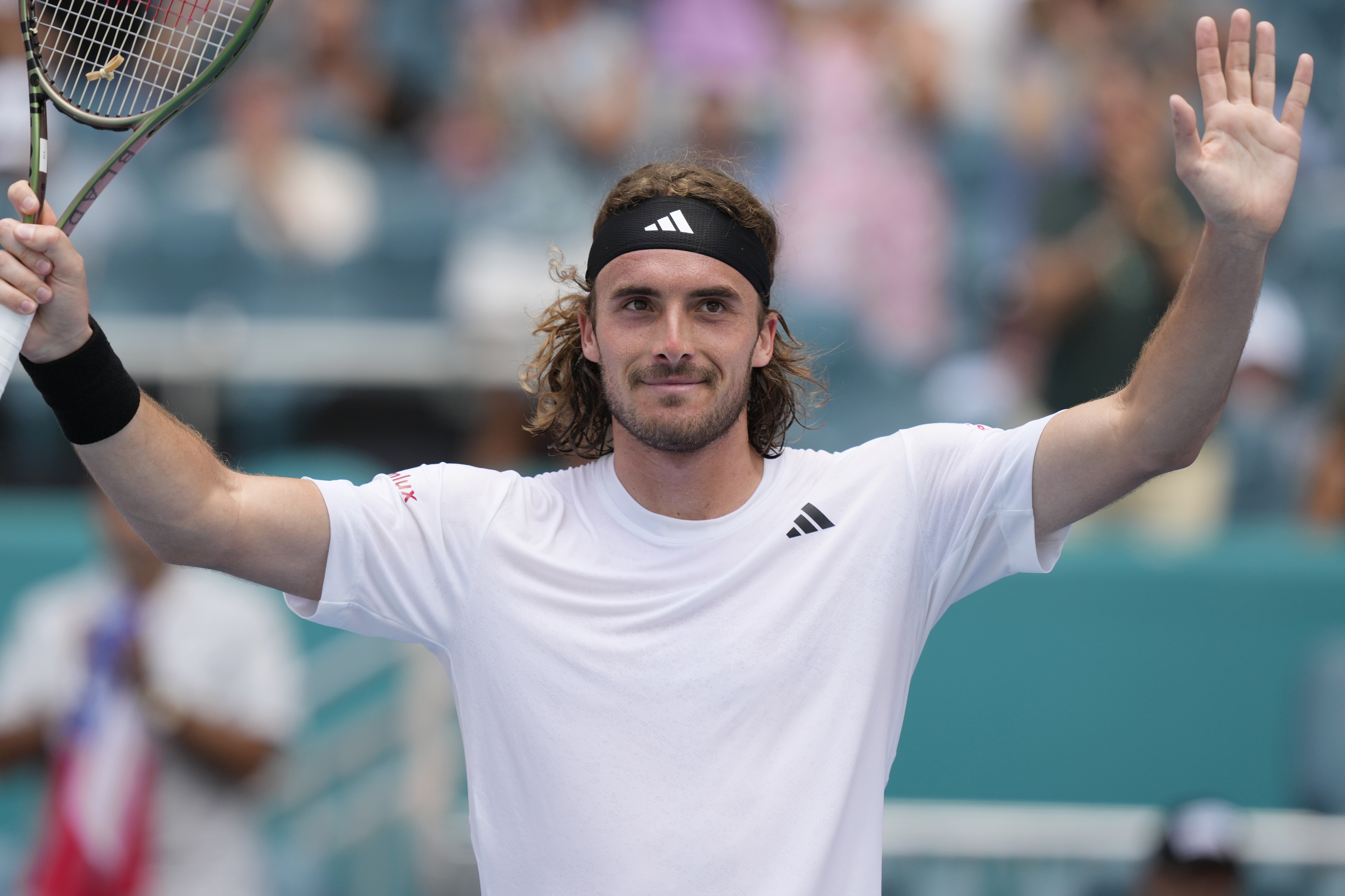 Stefanos Tsitsipas of Greece greets the fans after beating Cristian Garin of of Chile in the round of 16 of the Miami Open on Monday, March 27, 2023. (AP Photo/Marta Lavandier)