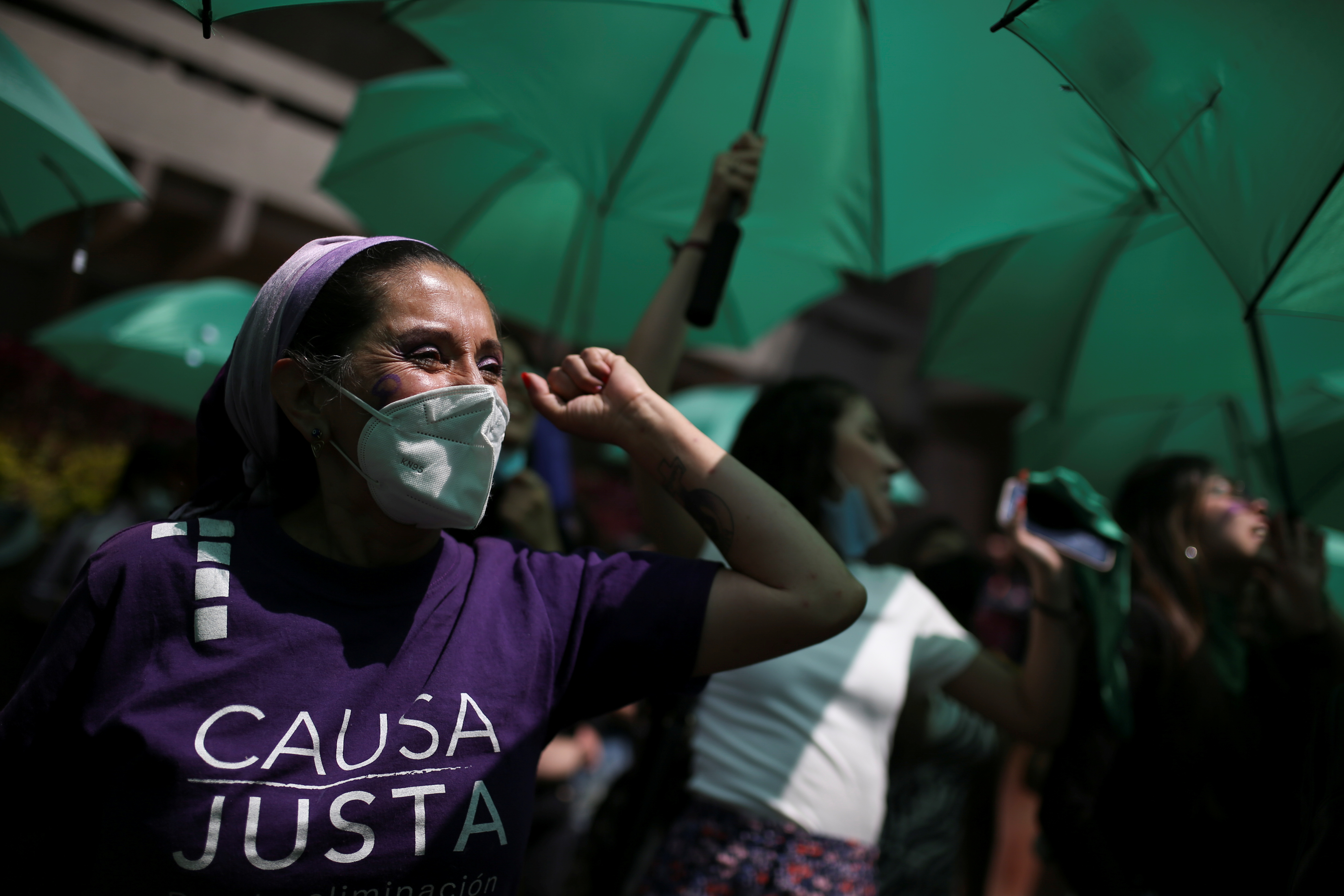 A woman wears a T-shirt reading "just cause" as women demonstrate in front of Colombia's constitutional court in support of removing abortion from the penal code, in Bogota, Colombia November 18, 2021. REUTERS/Luisa Gonzalez