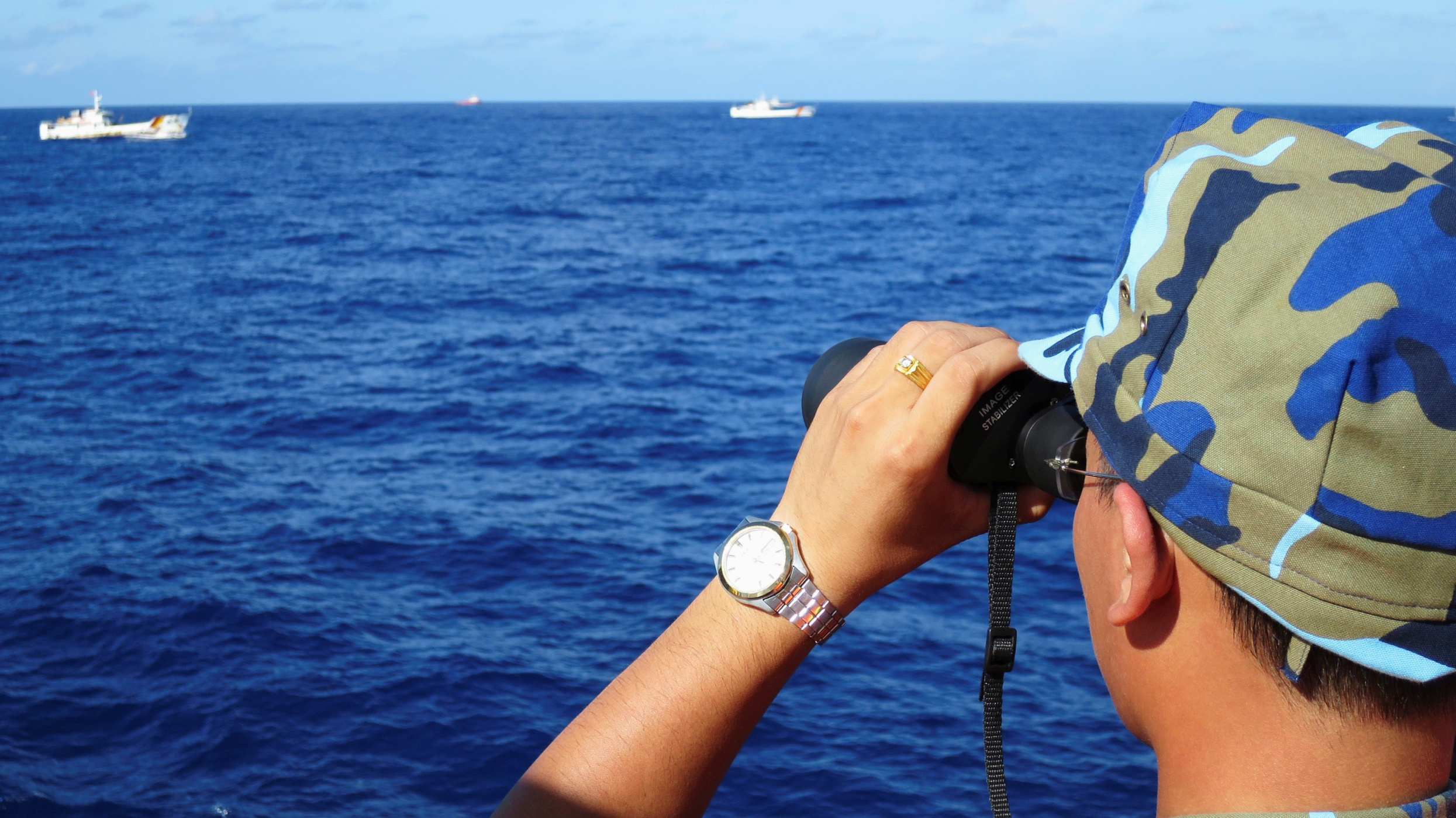 FILE PHOTO: A crewman from Vietnamese coastguard ship 8003 looks out at sea as Chinese coastguard vessels give chase to Vietnamese ships that came close to Haiyang Shiyou 981, known in Vietnam as HD-981, oil rig in South China Sea