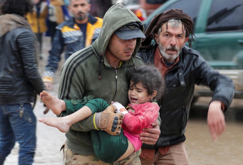 Un hombre lleva a una niña tras un terremoto, en la ciudad rebelde de Jandaris, Siria. 6 de febrero de 2023. REUTERS/Khalil Ashawi