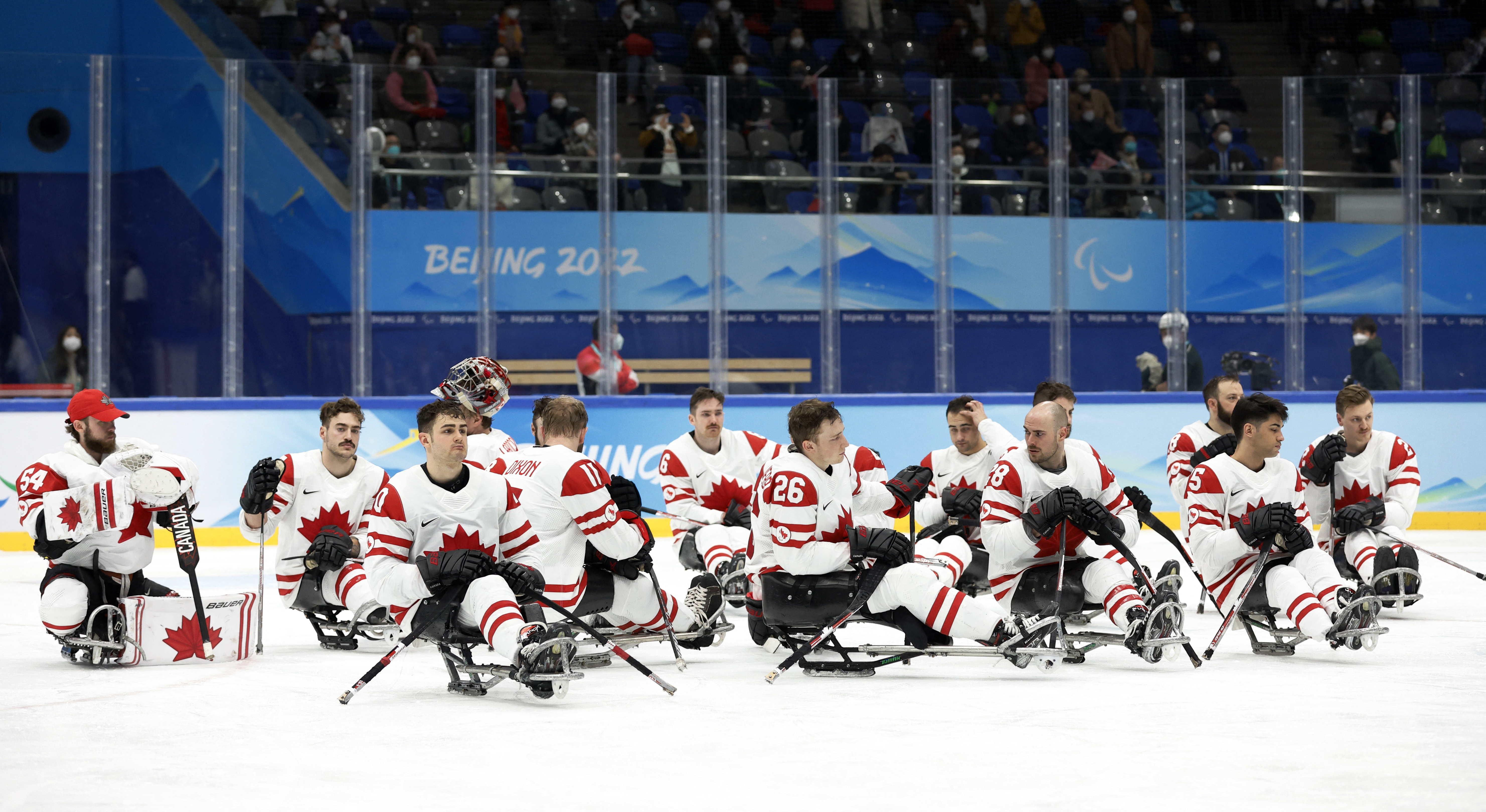 Beijing 2022 Winter Paralympic Games - Para Ice Hockey - Gold Medal Match - United States v Canada - National Indoor Stadium, Beijing, China - March 13, 2022. Silver medallists team Canada players look dejected during the medal ceremony. REUTERS/Peter Cziborra