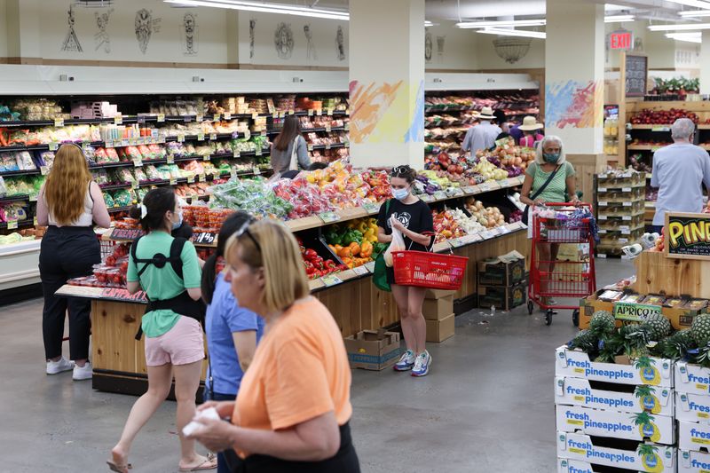 People shop at a supermarket in Manhattan, New York, United States