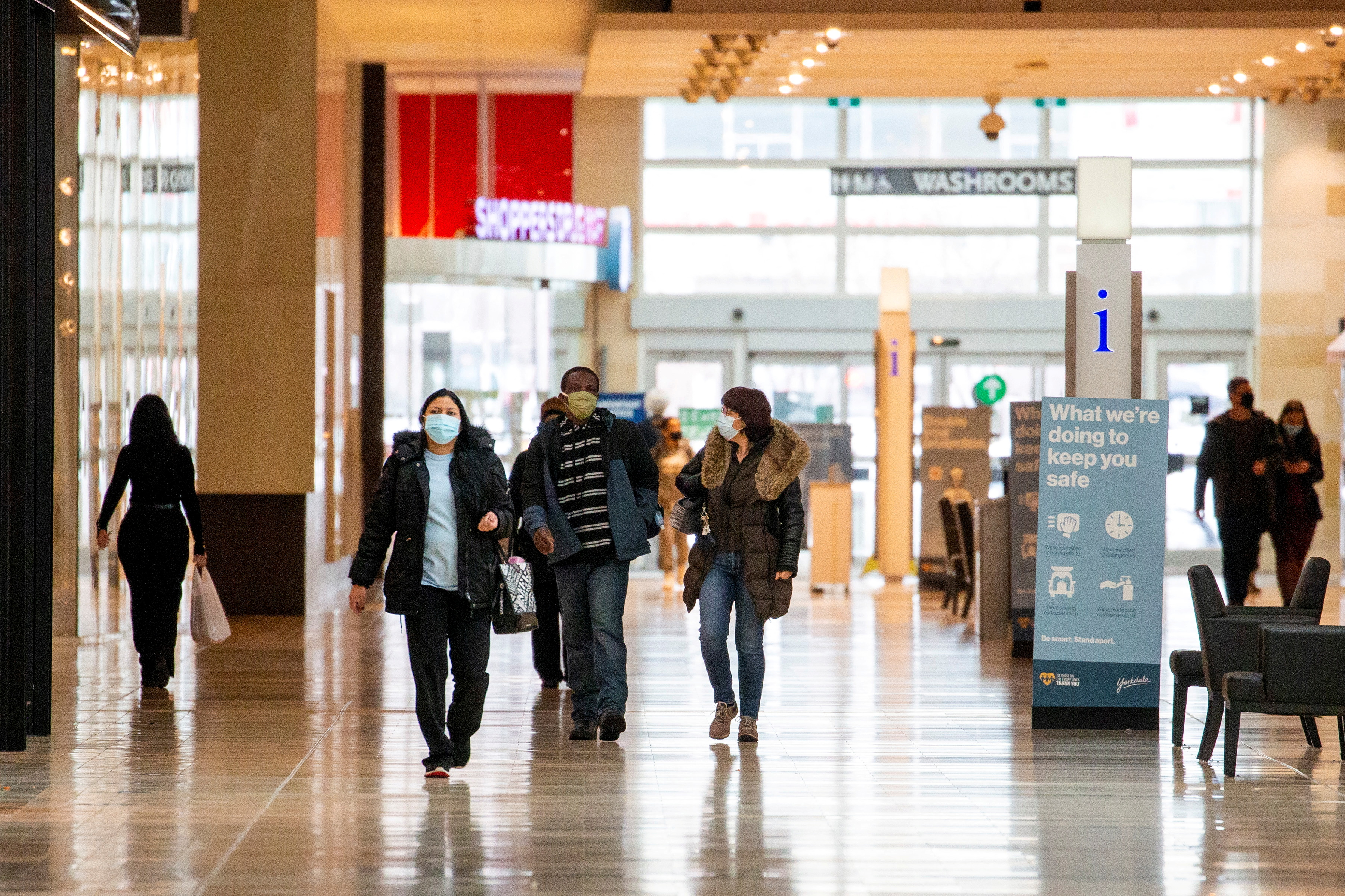 FILE PHOTO: People walk inside Yorkdale Shopping Centre as the city enters the first day of a renewed coronavirus lockdown due to a spike in cases in Toronto, Ontario, Canada November 23, 2020.  REUTERS/Carlos Osorio/File Photo