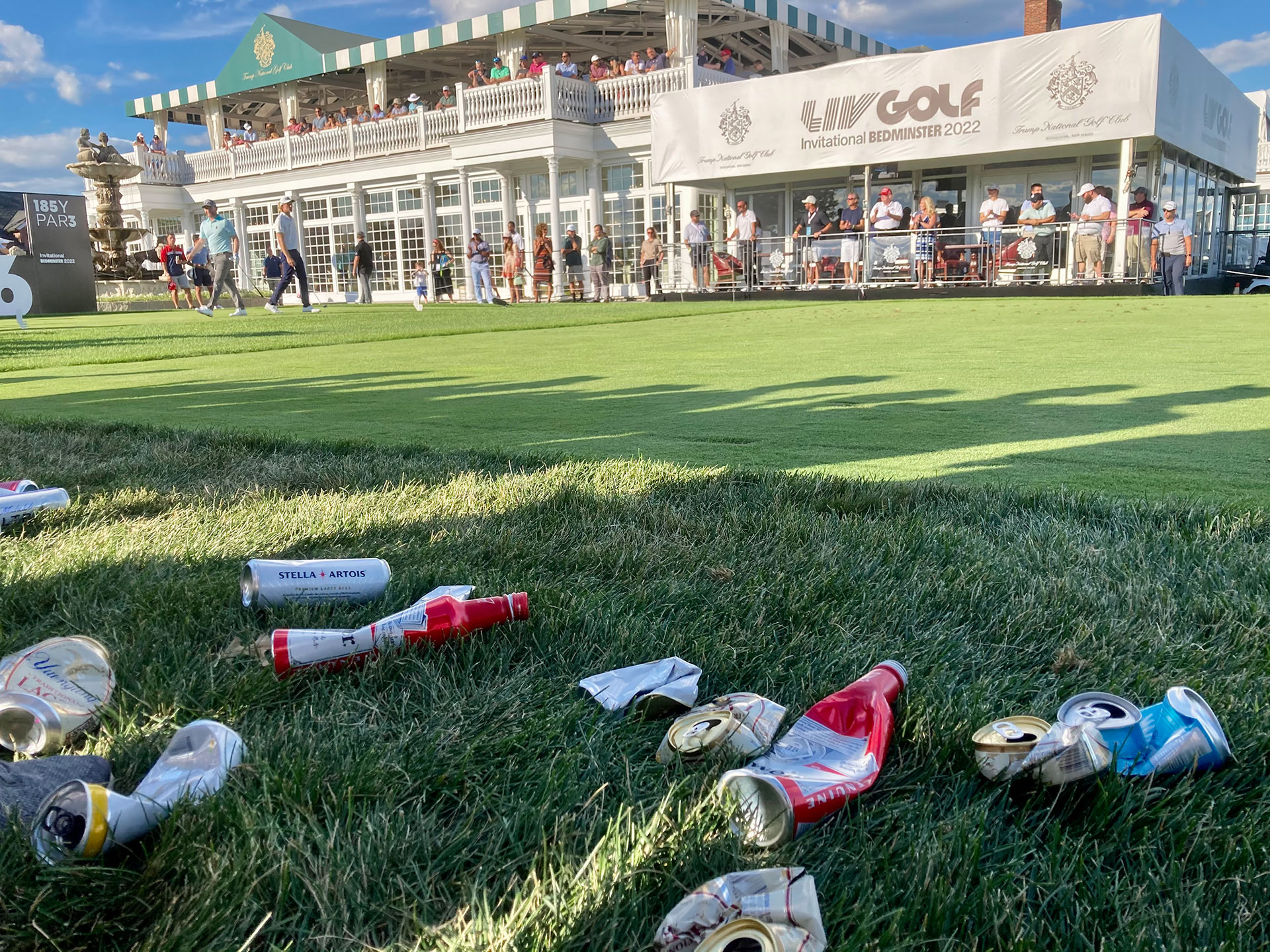 Beer cans are strewn alongside the 16th tee, after Eric Trump offered up the free beverages to fans at Trump National Golf Club in Bedminster on Saturday afternoon
