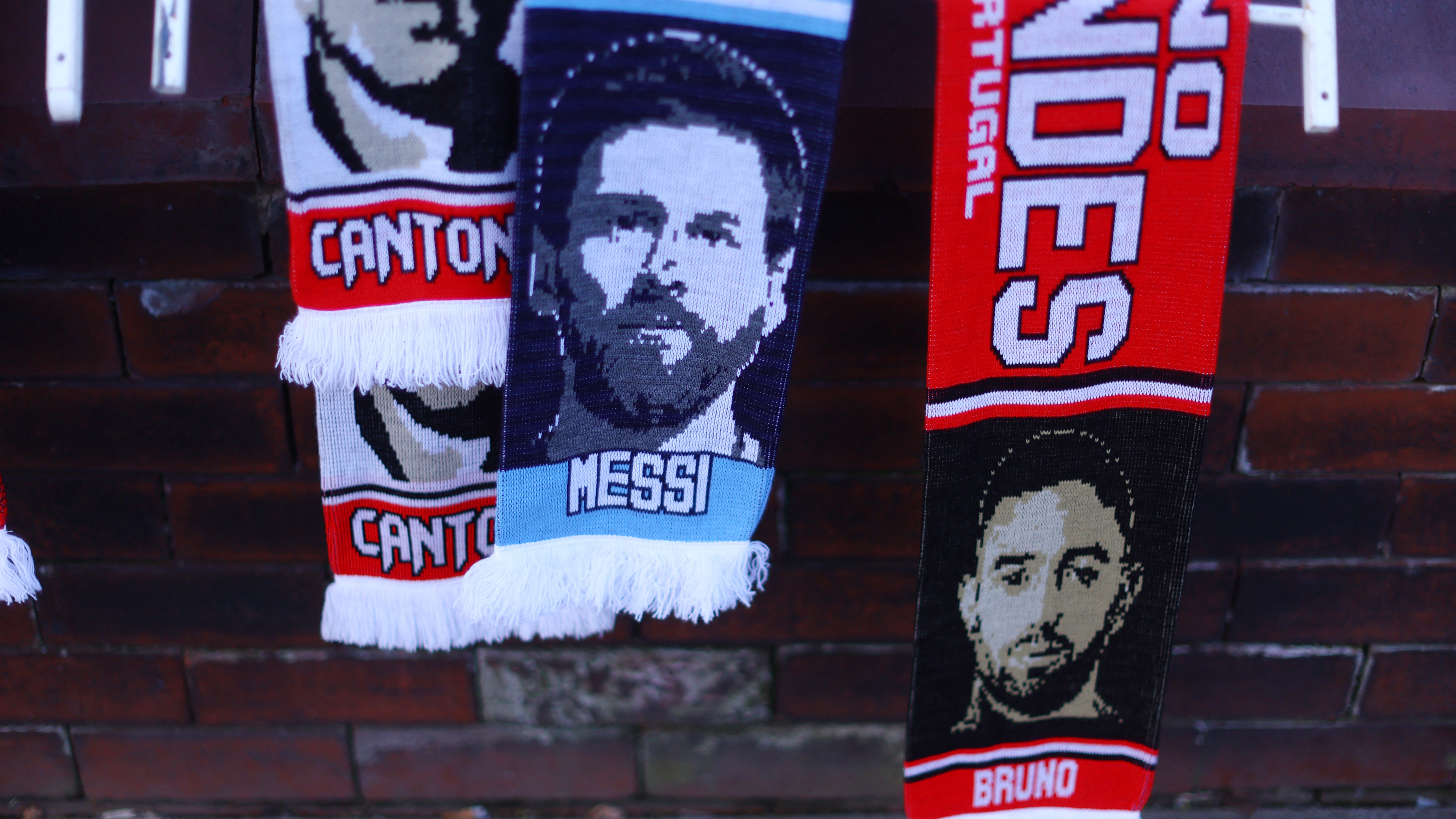 Soccer Football - Europa League - Quarter Final - First Leg - Manchester United v Sevilla - Old Trafford, Manchester, Britain - April 13, 2023  General view as scarfs of Manchester United's Bruno Fernandes and Argentina's Lionel Messi are seen outside the stadium before the match REUTERS/Carl Recine