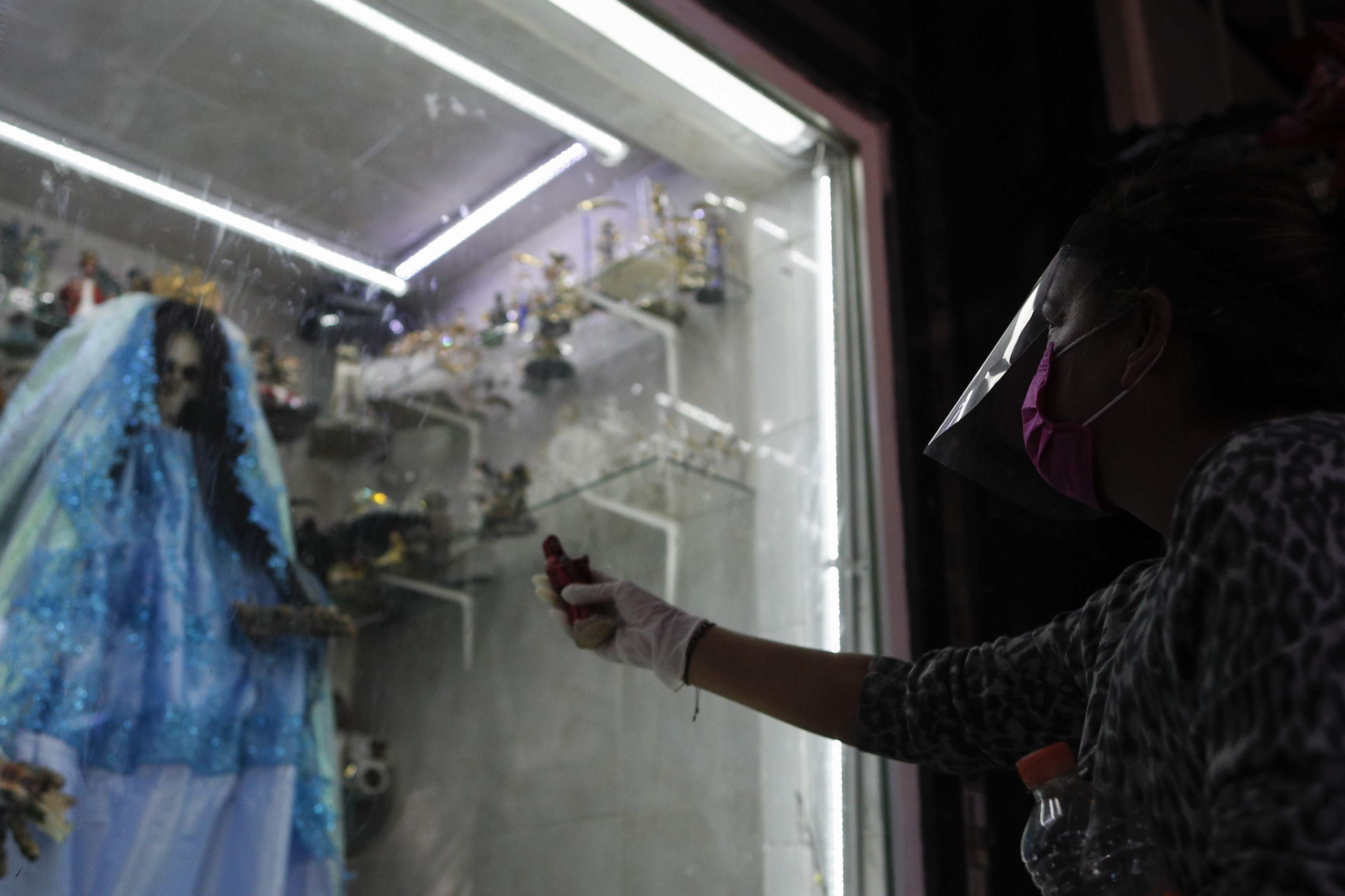 Un devoto que lleva una máscara facial de plástico rinde homenaje a la Santa Muerte. (Foto: AP / Rebecca Blackwell)