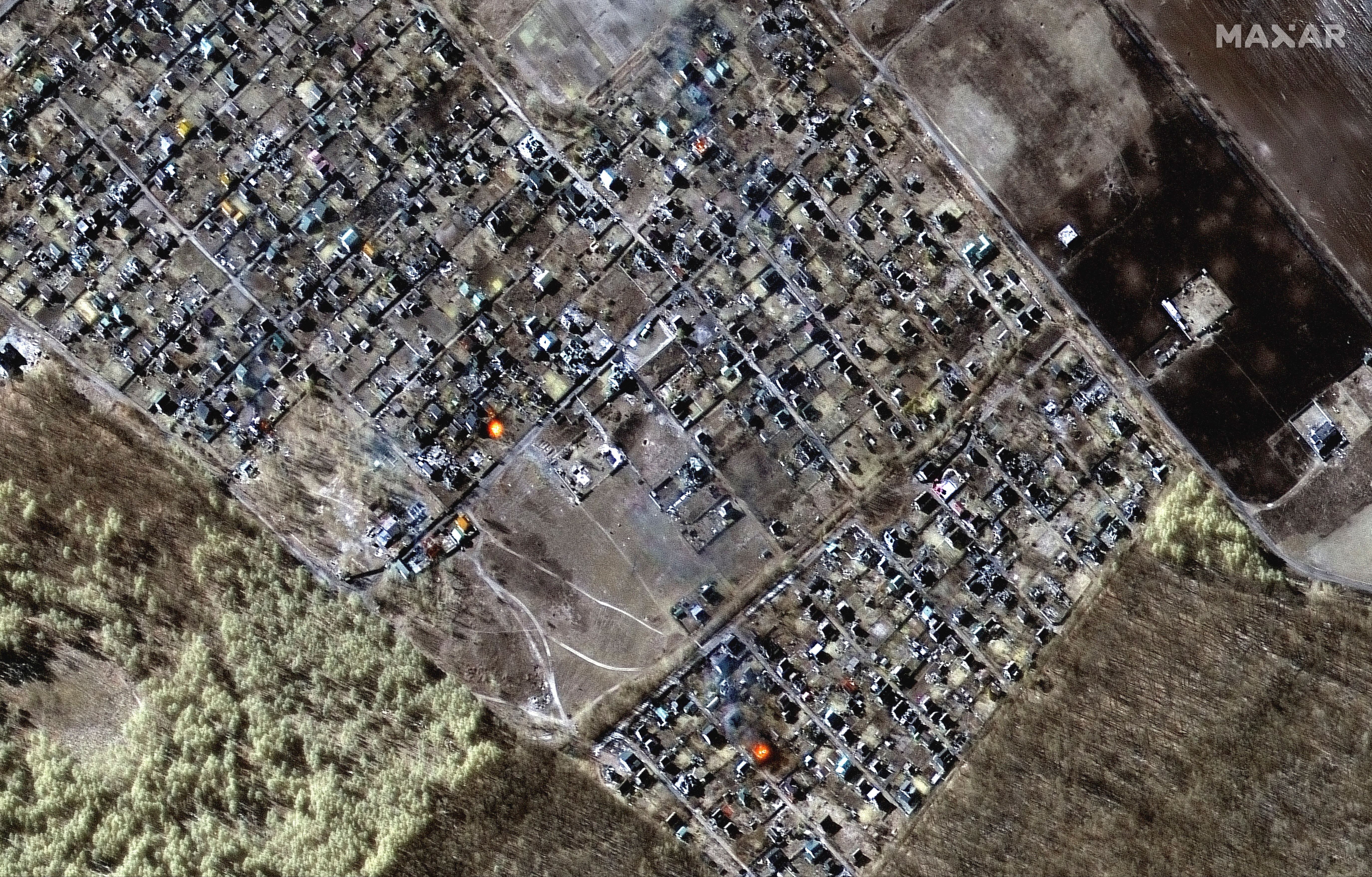 Una imagen satelital muestra una visión general multiespectral de las casas en llamas en Moschun, Ucrania, este 11 de marzo de 2022 (Maxar Technologies/REUTERS)