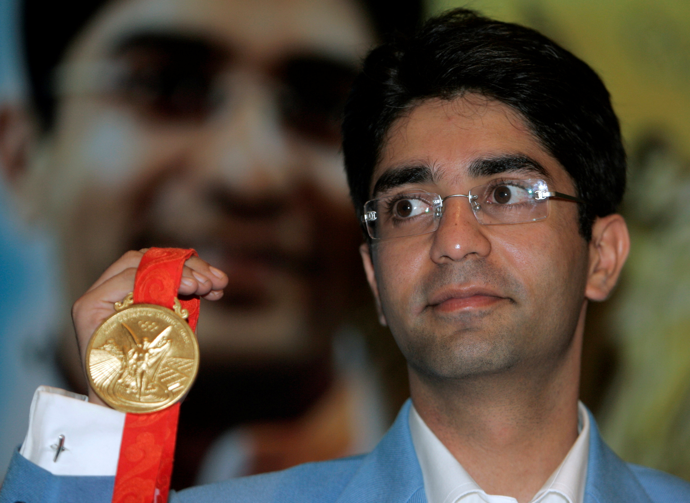 FILE PHOTO: Olympic men's 10m air rifle gold medalist Abhinav Bindra shows his gold medal during a news conference in New Delhi August 14, 2008. Ecstatic India lavished praise and nearly $400,000 in cash on shooter Bindra after he won the first solo Olympic title for a medal-starved nation. REUTERS/Parth Sanyal  (INDIA)/File Photo