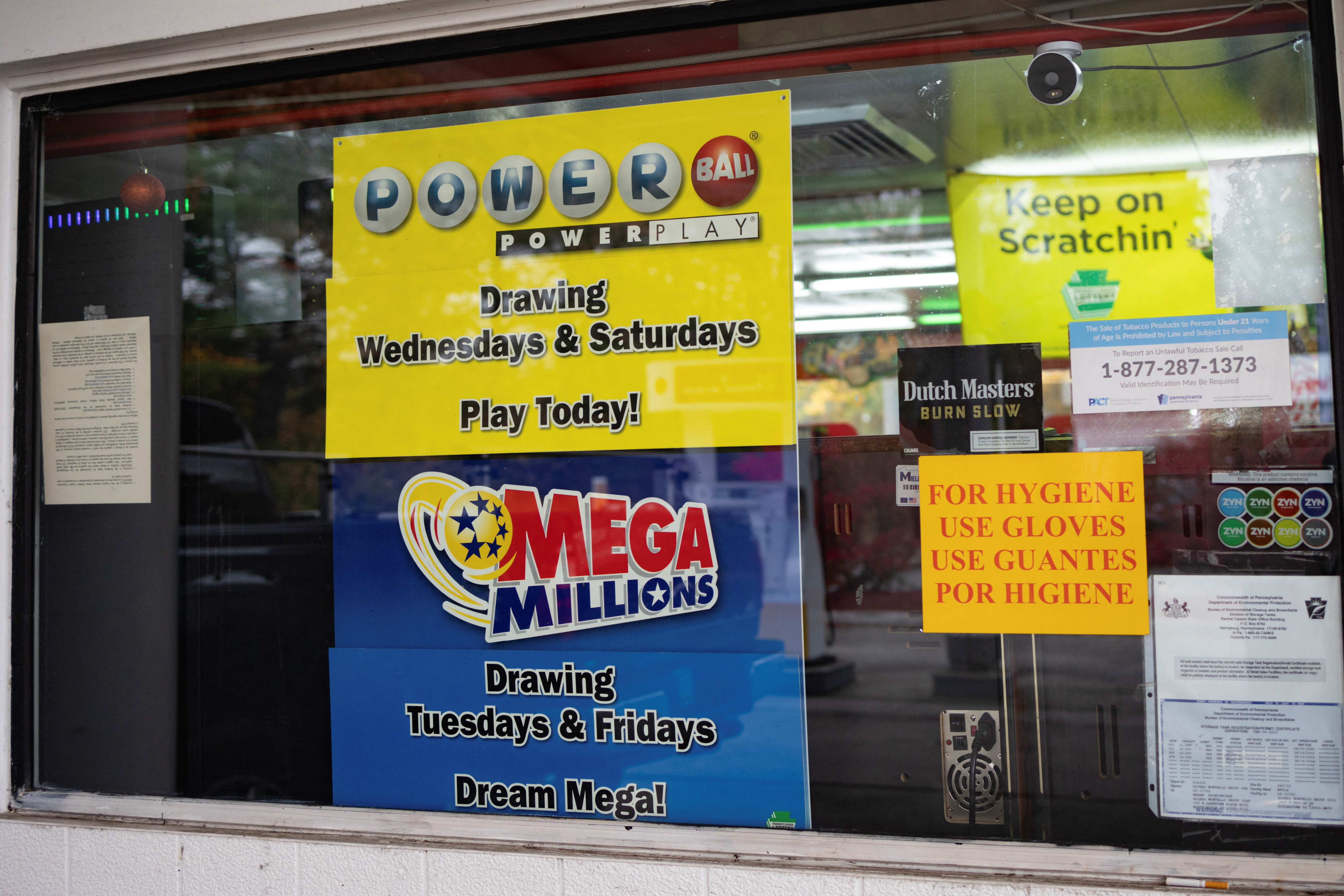 A lottery sign is displayed at a gas station as the Powerball lottery jackpot hits $1 billion in Doylestown, Pennsylvania, U.S. October 31, 2022.  REUTERS/Hannah Beier