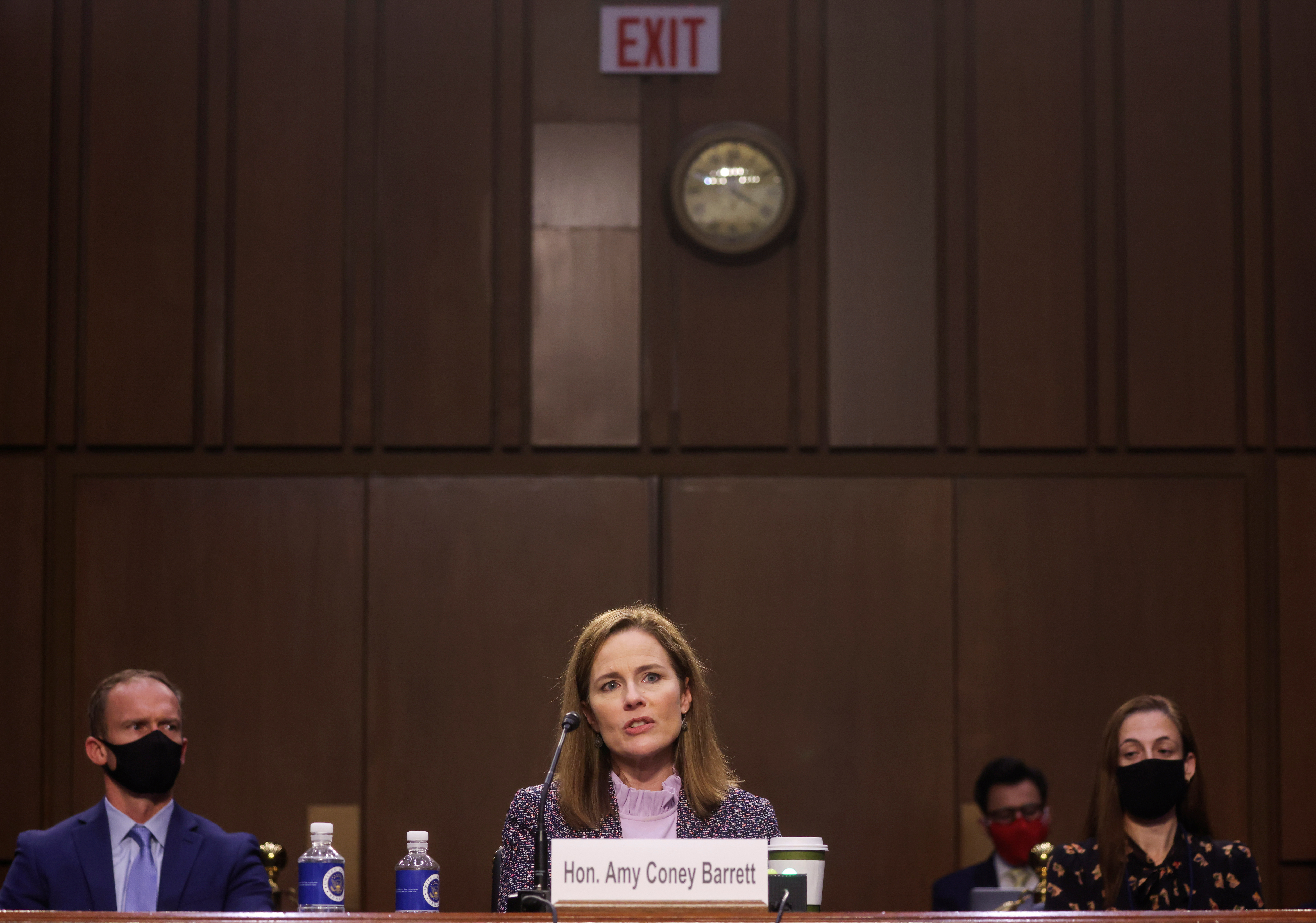 U.S. Supreme Court nominee Judge Amy Coney Barrett testifies on the third day of her U.S. Senate Judiciary Committee confirmation hearing as her husband, Jesse, listens on Capitol Hill in Washington, U.S., October 14, 2020. REUTERS/Jonathan Ernst/Pool