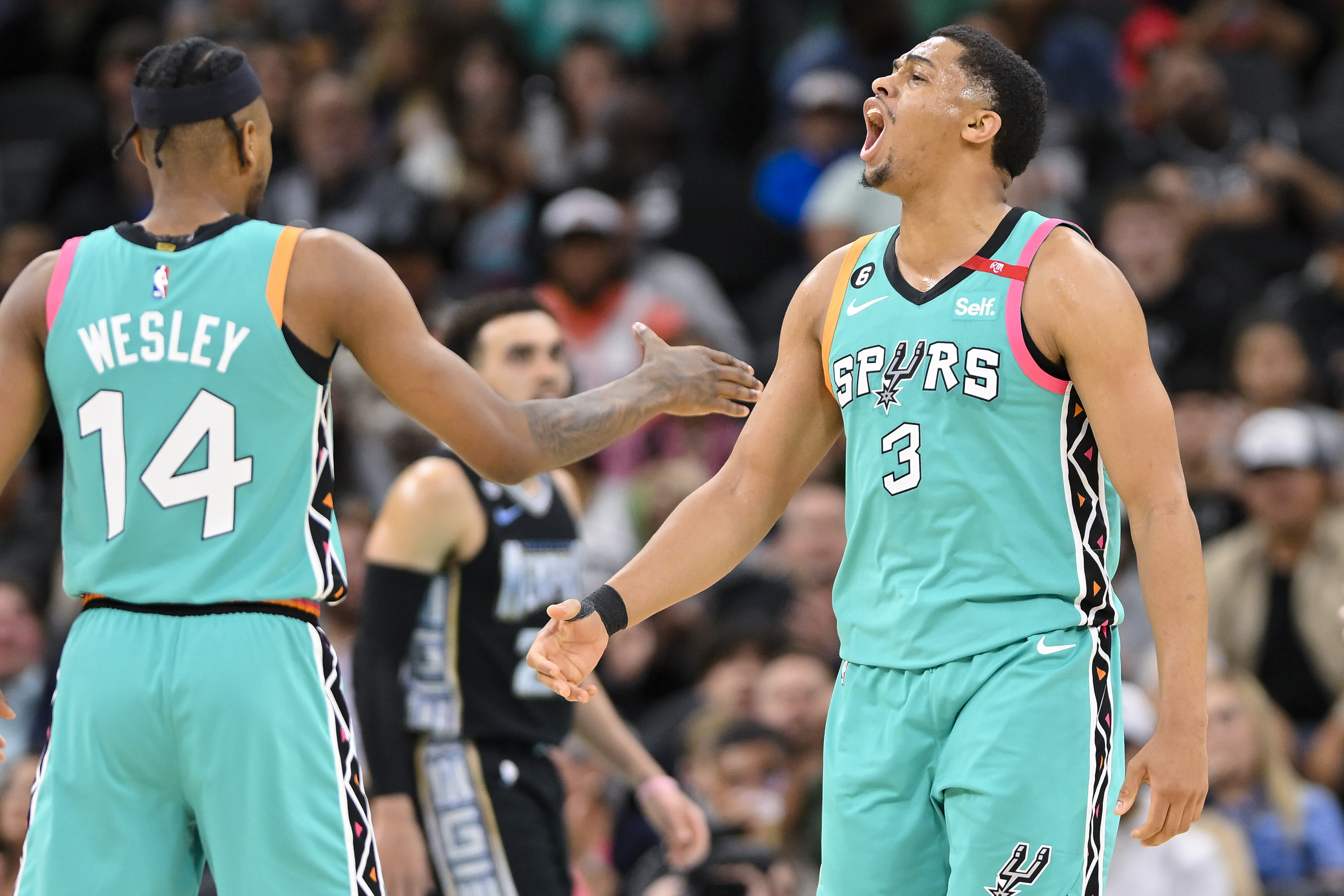 San Antonio Spurs players Keldon Johnson (3) and Blake Wesley celebrate a basket during the second half of an NBA game against the Memphis Grizzlies on March 17, 2023 in San Antonio.  (AP Photo/Darren Abate)