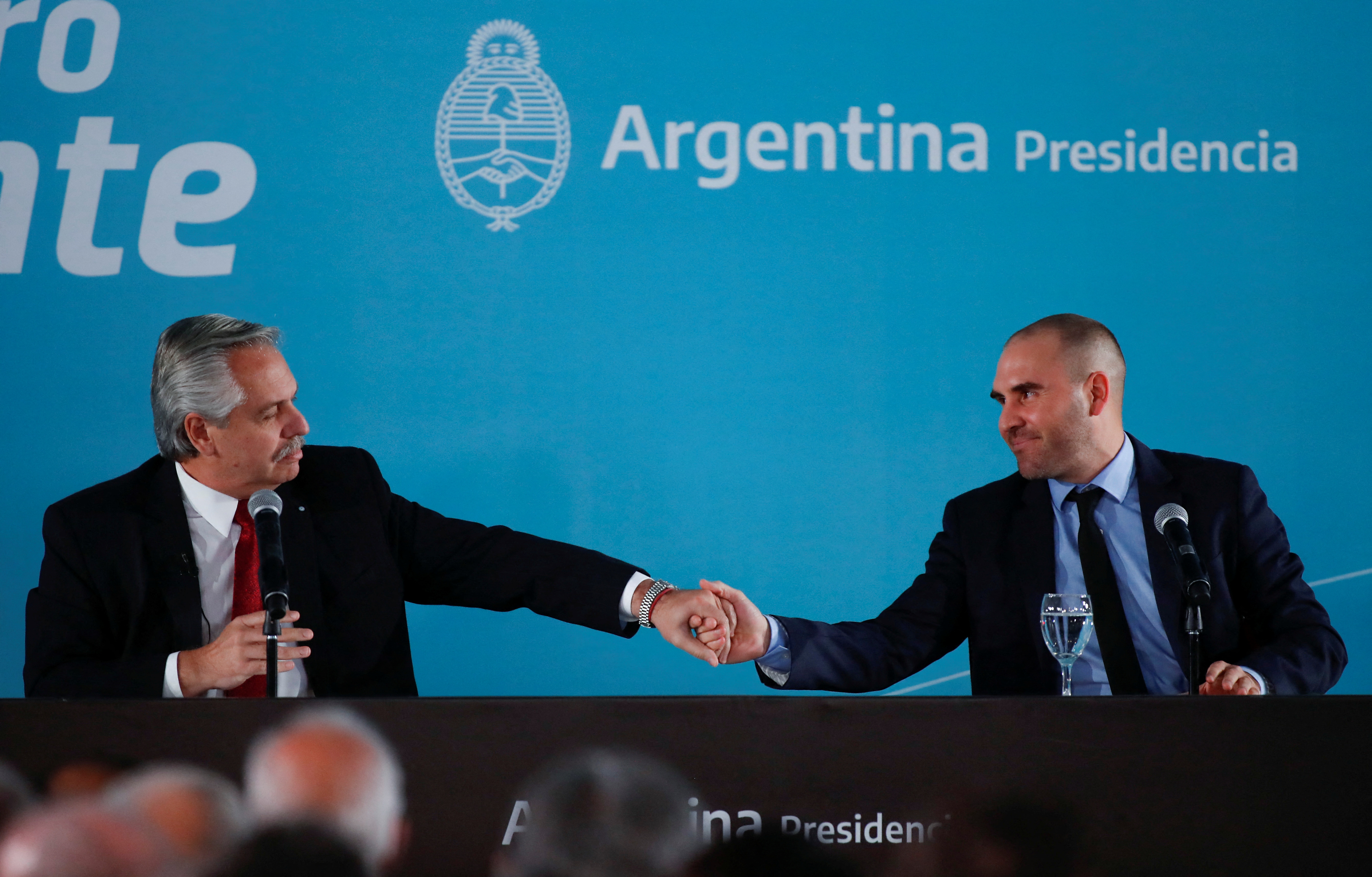 Argentine President Alberto Fernandez shakes hands with Argentine Economy Minister Martin Guzman during announcement of creation of a tax on a so-called "extraordinary profits" for big companies that earned more-than-expected due to the war in Ukraine, at the Museo del Bicentenario in Casa Rosada presidential palace, in Buenos Aires, Argentina June 6, 2022. REUTERS/Agustin Marcarian