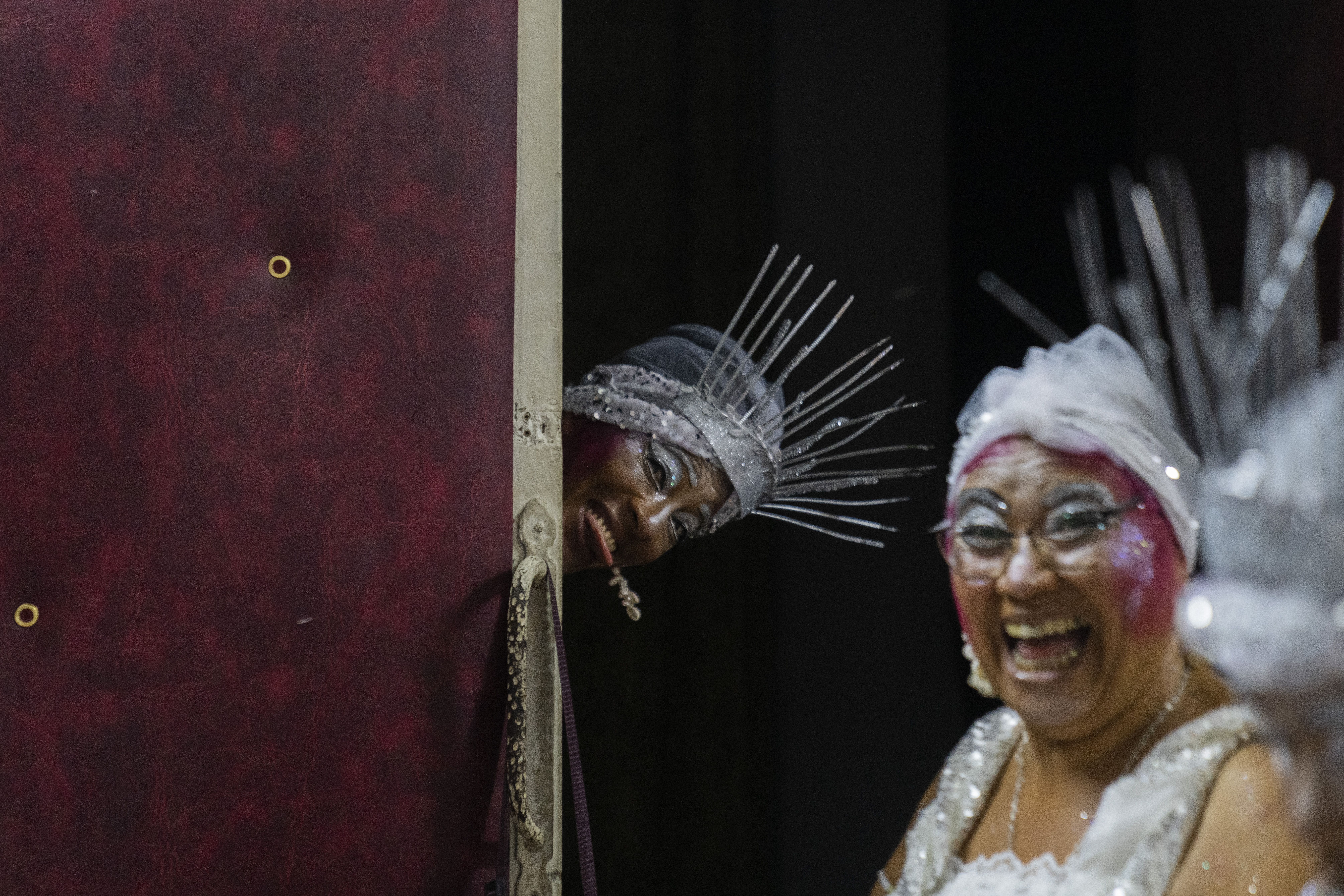Bailarinas de candombe ríen mientras se preparan para actuar en el desfile de Carnaval "Las llamadas", en Montevideo, Uruguay, el 10 de febrero de 2023. (AP Foto/Matilde Campodonico)