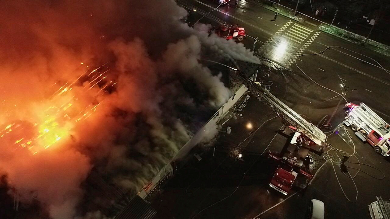 Firefighters work to extinguish the fire in a Russian bar 