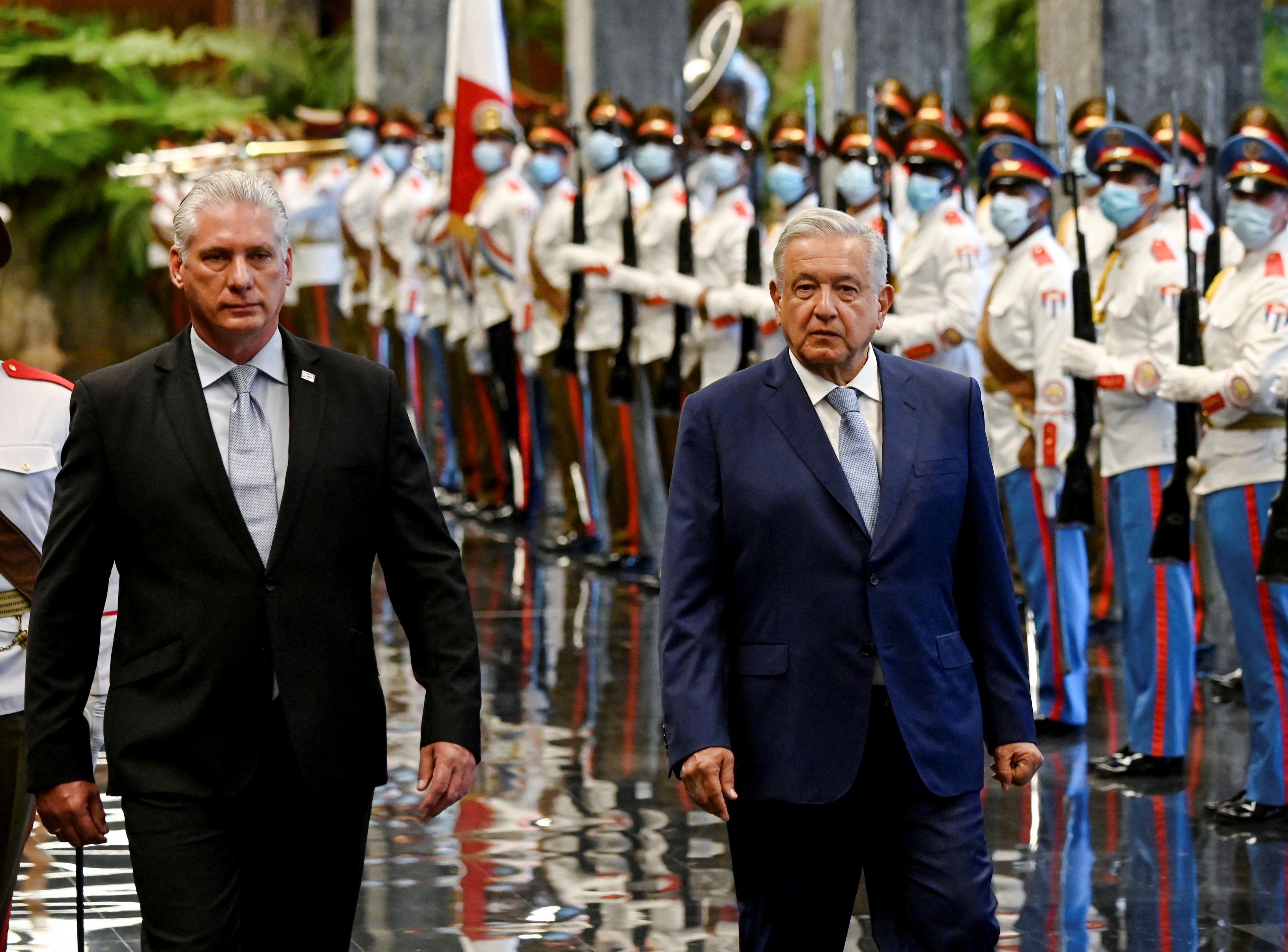 Cuba's President Miguel Diaz-Canel and Mexico's President Andres Manuel Lopez Obrador walk at the Revolution Palace, during Lopez's visit to Cuba, in Havana, Cuba May 8, 2022. Yamil Lage/Pool via REUTERS
