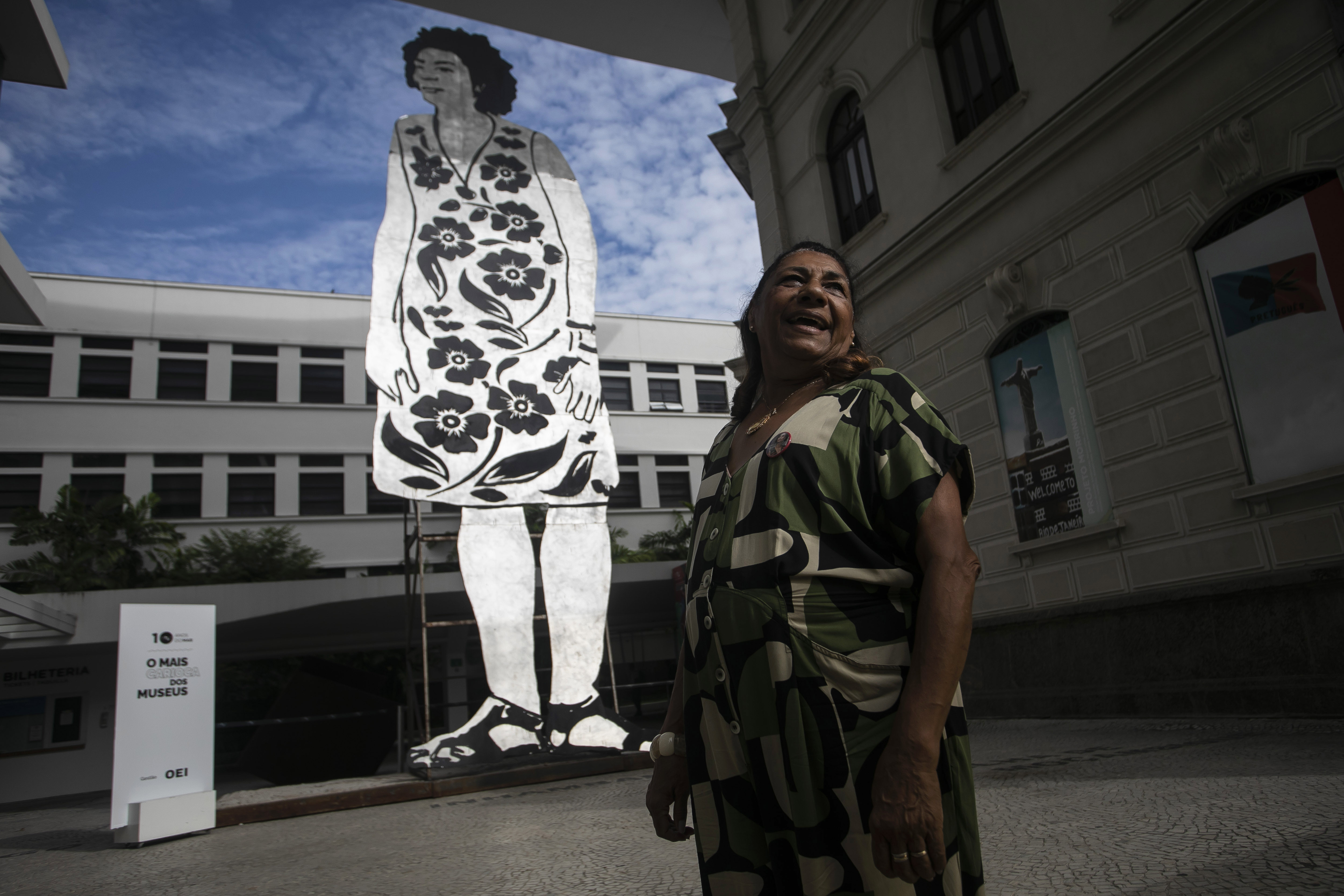 Marinette da Silva, madre de la concejal asesinada Marielle Franco, de pie junto a un cartón enorme que muestra a Franco, durante un tributo para conmemorar el 5to aniversario de su asesinato, en el Museo de Arte de Río de Janeiro, el martes 14 de marzo de 2023. (AP Foto/Bruna Prado)