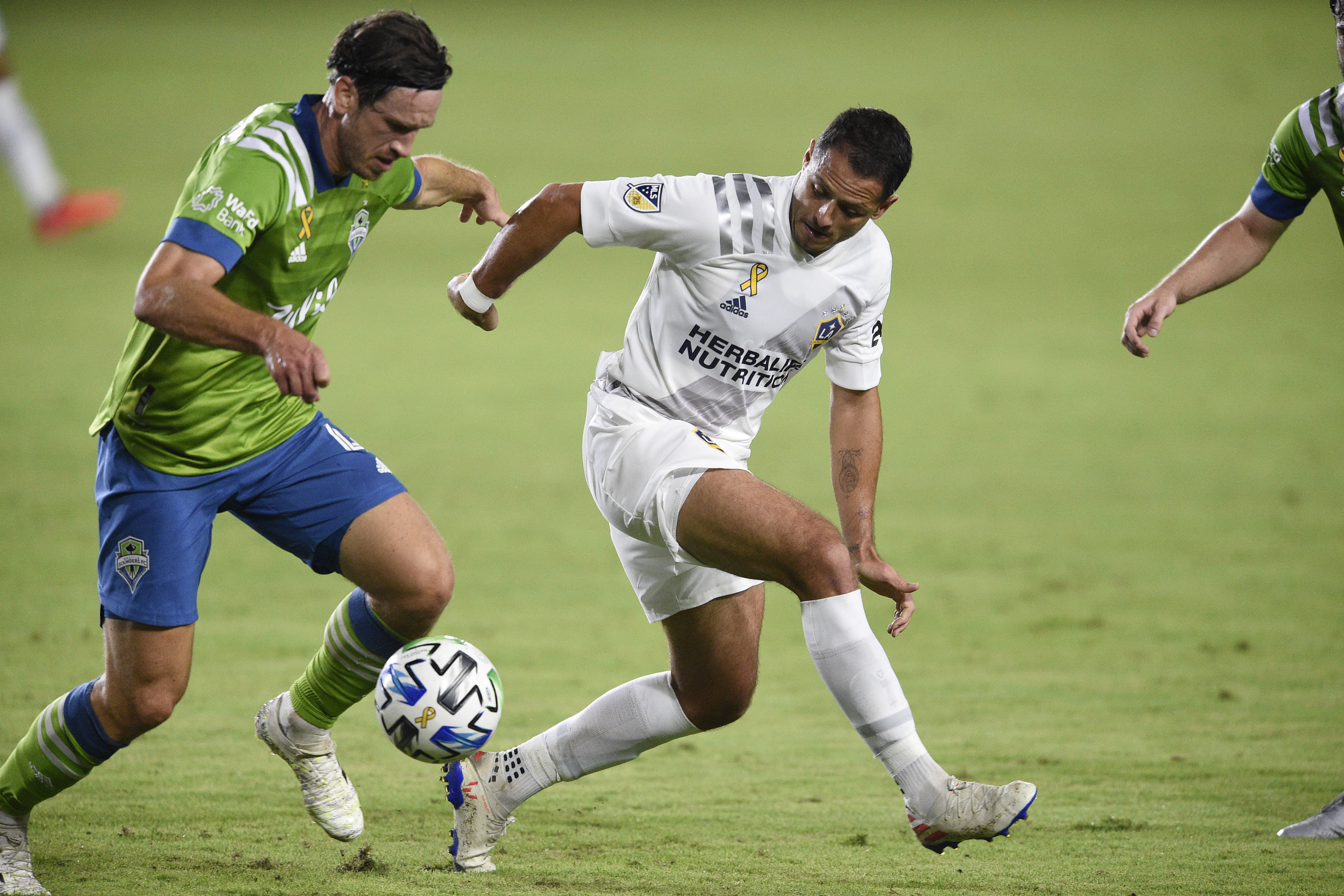 Sep 27, 2020; Carson, California, USA; Seattle Sounders midfielder Gustav Svensson (4) and LA Galaxy forward Javier Hernández (14) battle for the ball during the first half at Dignity Health Sports Park. Mandatory Credit: Kelvin Kuo-USA TODAY Sports