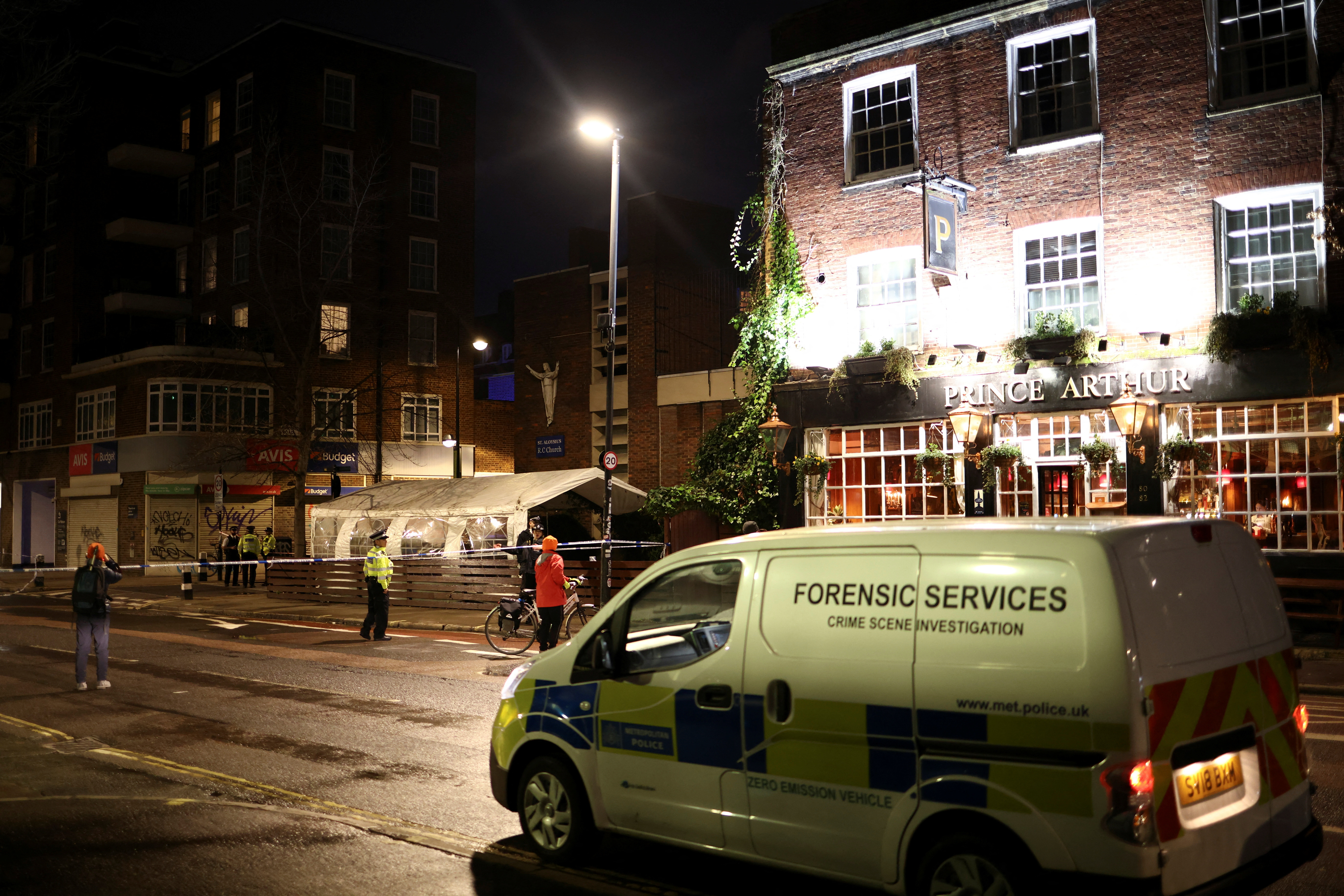 General view shows police at the scene of a shooting, the attack reportedly happened during a funeral at St Aloysius Church, in London, Britain, January 14, 2023. REUTERS/Henry Nicholls