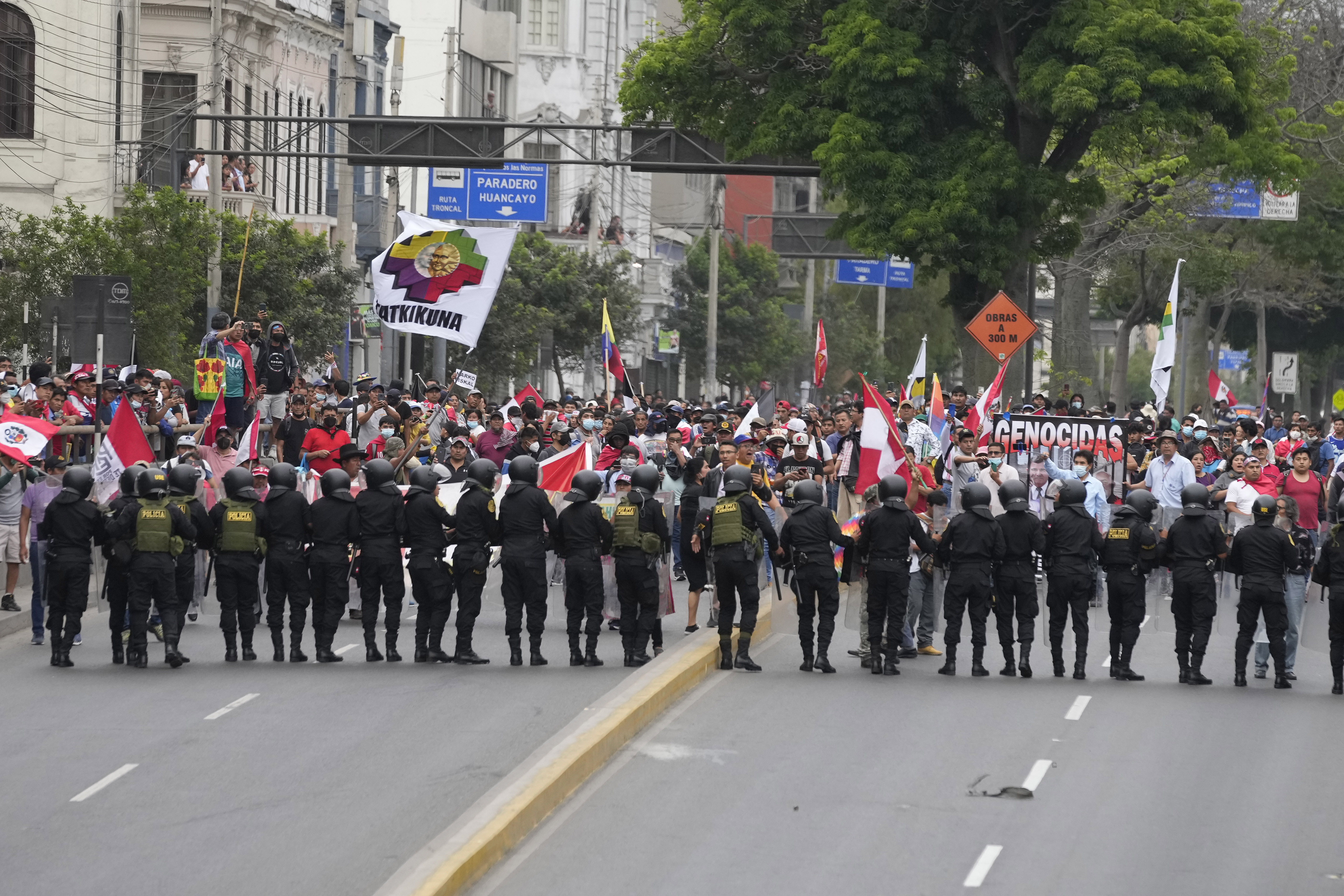 Manifestantes que viajaron a la capital desde otras partes del país se enfrentan a una línea de policías antimotines. (AP Foto/Martín Mejía)