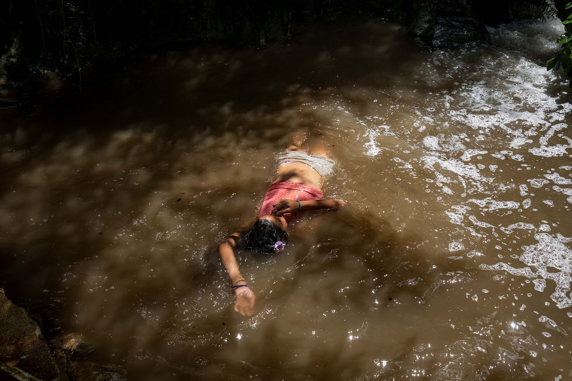 Una niña se baña en una quebrada llamada "La Poza", en Caracas (EFE/ Miguel Gutiérrez)
