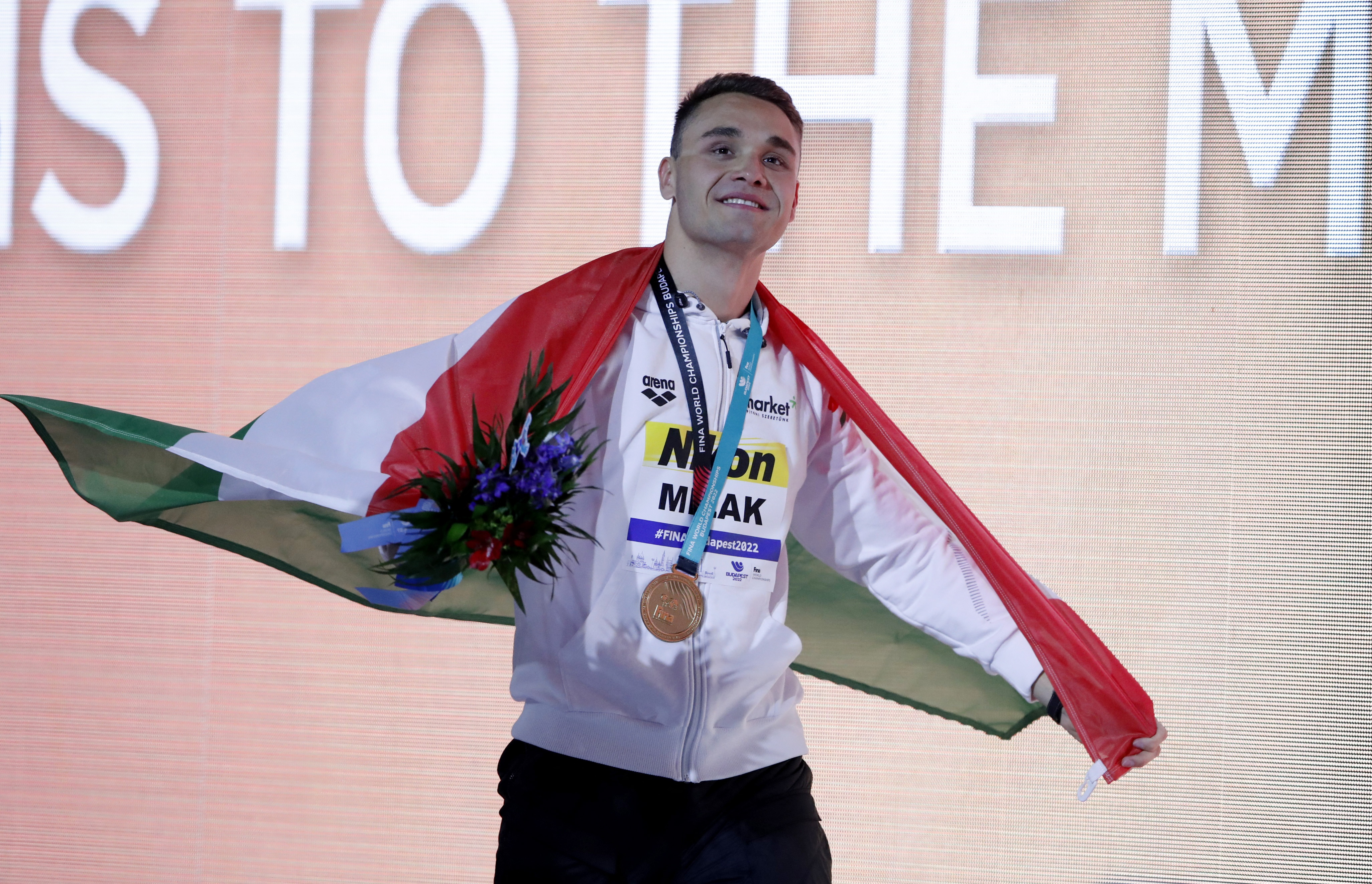 Swimming - FINA World Championships - Budapest, Hungary - June 21, 2022 Men's 200m butterfly gold medallist, Hungary's Kristof Milak celebrates on the podium after the final REUTERS/Bernadett Szabo