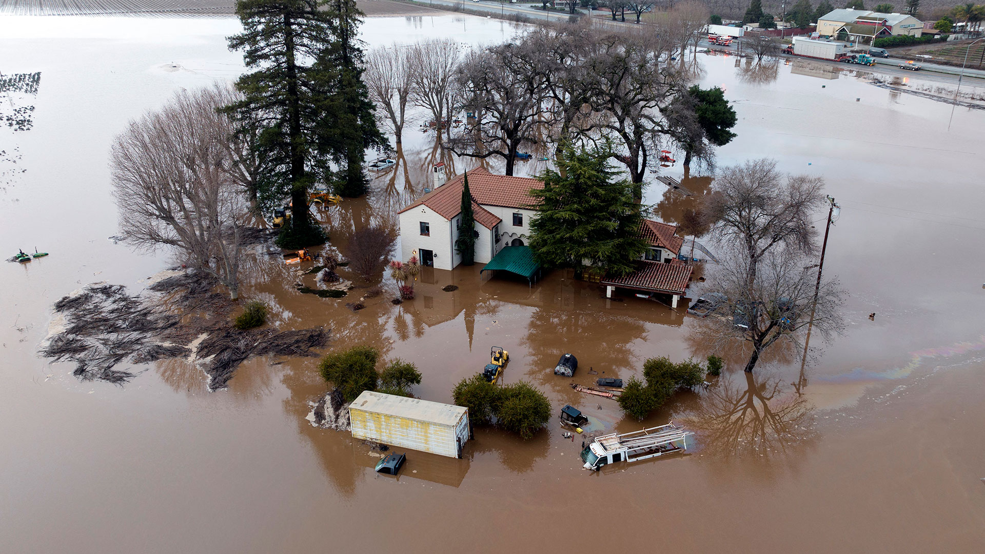 This aerial view shows a flooded house partially underwater in Gilroy, California, on January 9, 2023 (AFP)