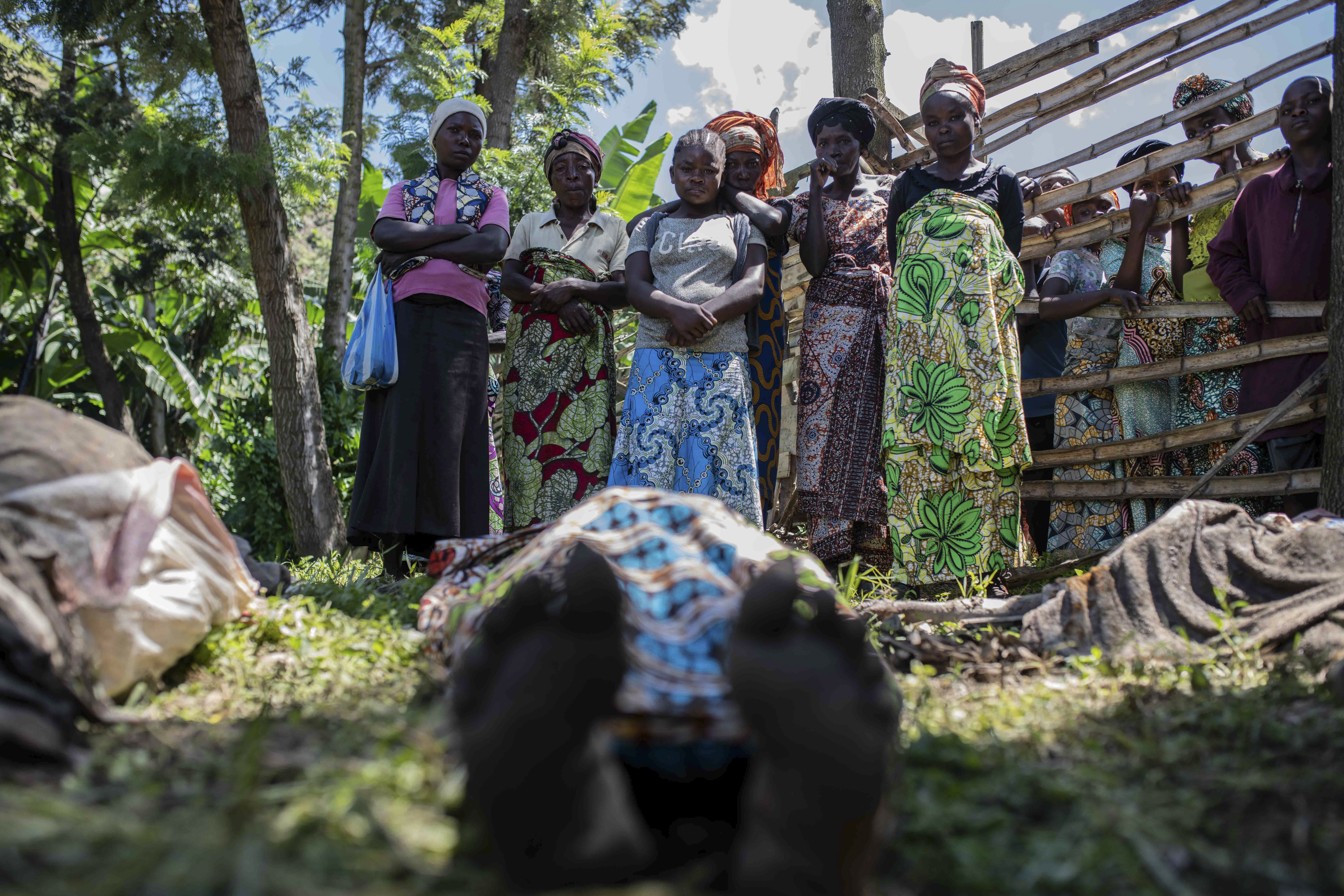 En esta fotografía del sábado 6 de mayo de 2023, familiares identifican a víctimas de inundaciones en la localidad de Nyamukubi, en la provincia de Kivu del Sur, República Democrática del Congo. (AP Foto/Moses Sawasawa)
