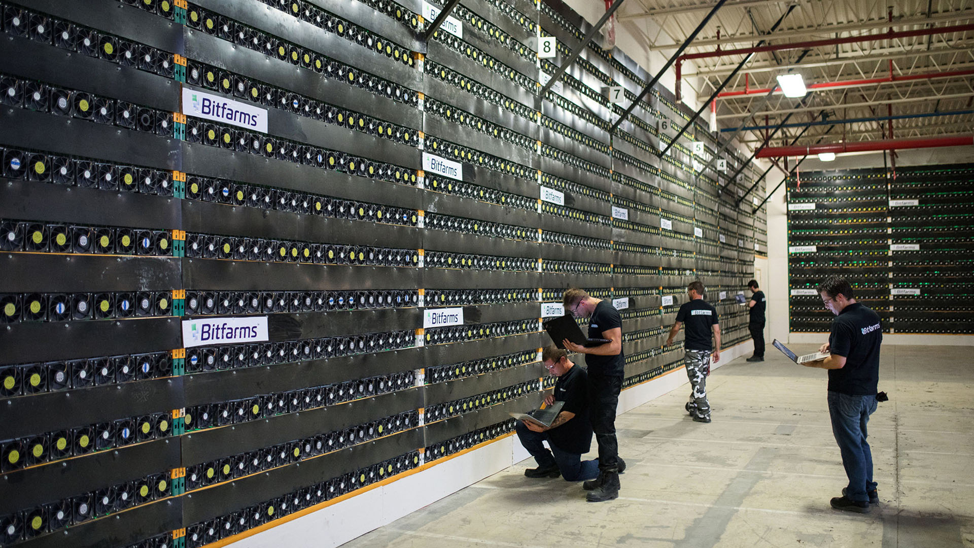 Technicians monitor cryptocurrency mining rigs at a Bitfarms facility in Saint-Hyacinthe, Quebec, Canada, on Thursday, July 26, 2018. Bitcoin has rallied more than 30 percent in July, shrugging off security and regulatory concerns that have plagued the virtual currency for much of this year. Photographer: James MacDonald/Bloomberg