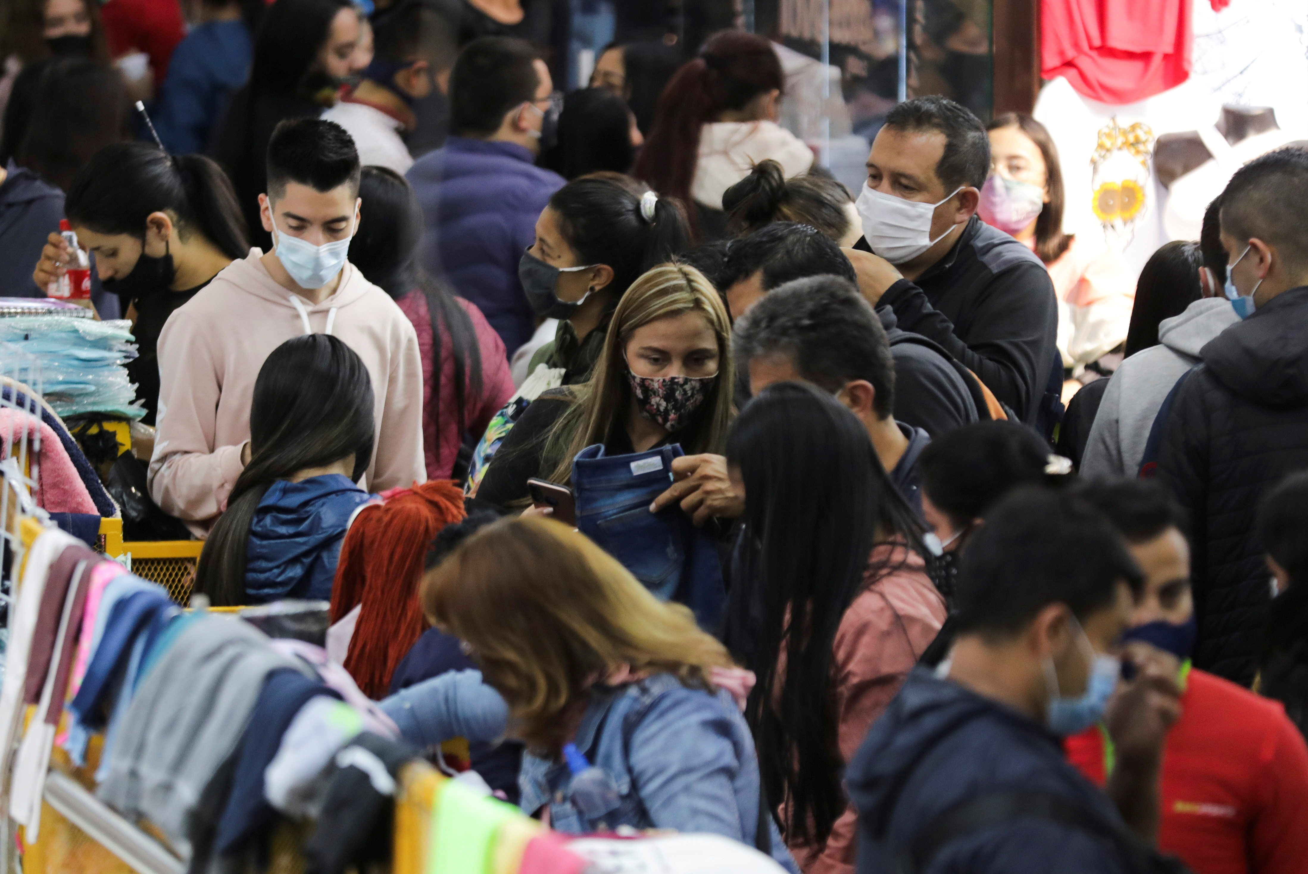 FILE PHOTO: People wearing face masks shop in the commercial sector of San Victorino during the Christmas sales season as the coronavirus disease (COVID-19) outbreak continues in Bogota, Colombia December 5, 2020. REUTERS/Luisa Gonzalez/File Photo