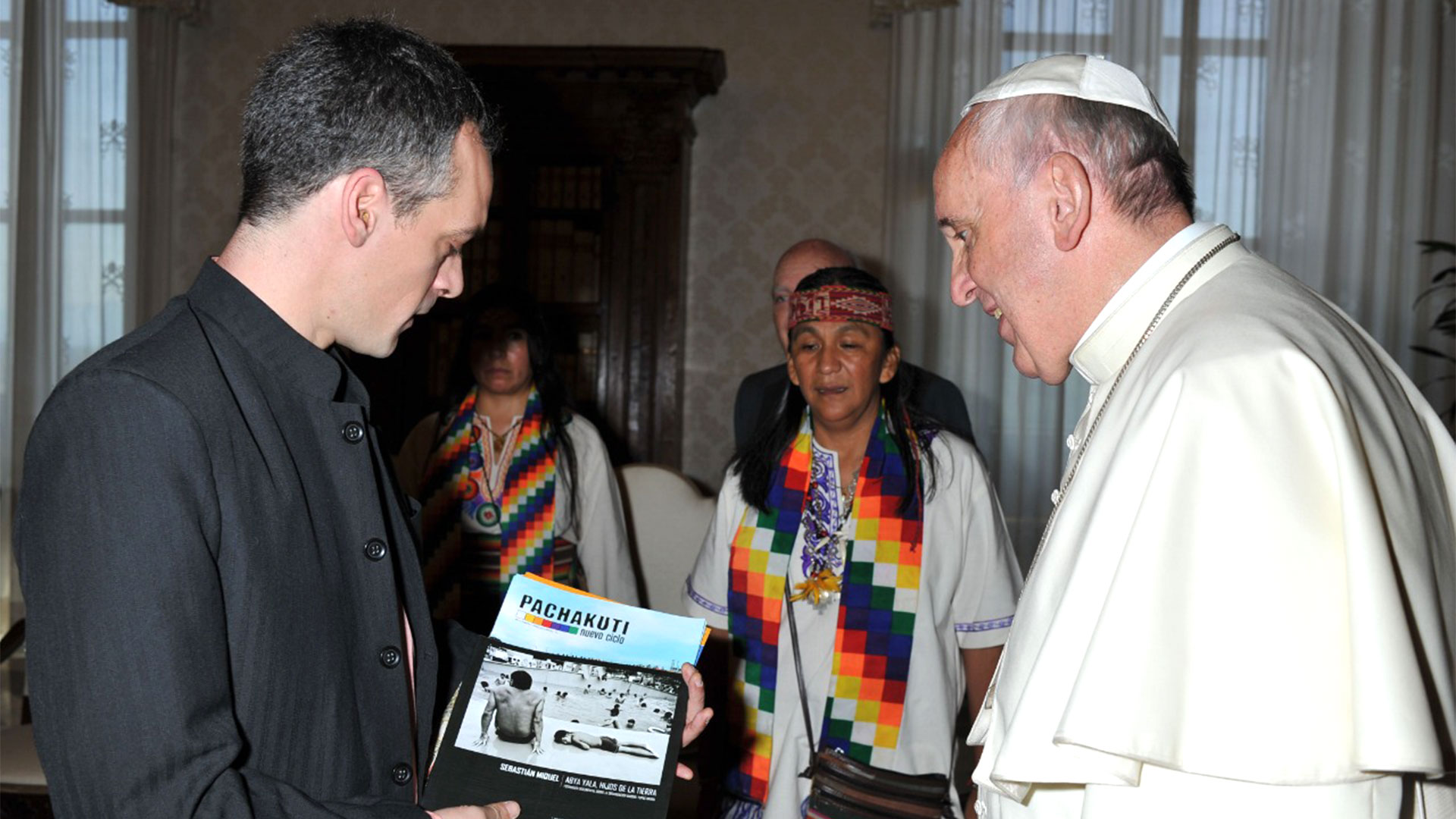 Pope Francis receives a copy of Pachakuti magazine