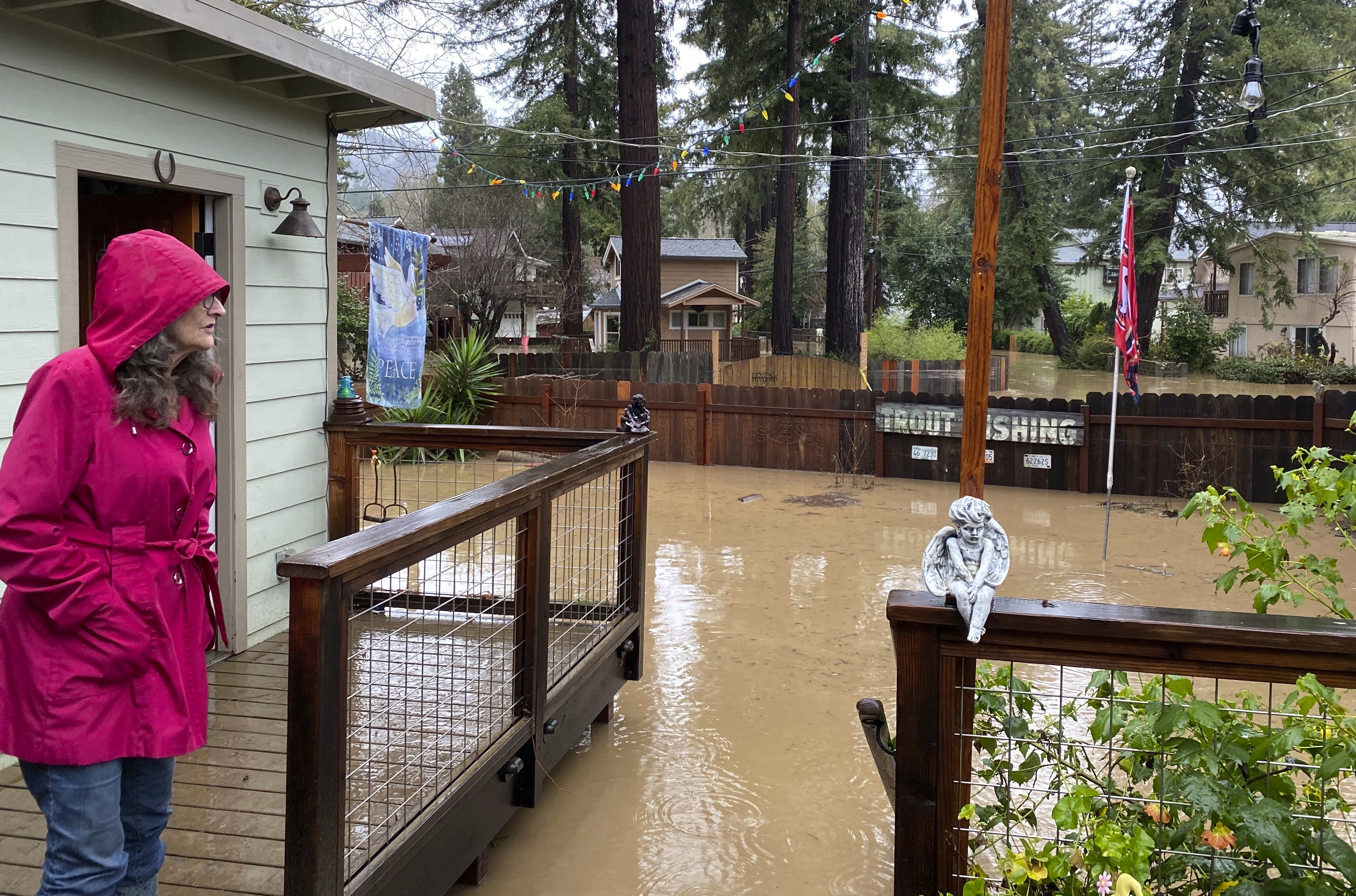 Linda Orengo, 69, looks at the flood damage at her home in Felton, Santa Cruz County, Calif. (John Woolfolk/Bay Area News Group via AP)