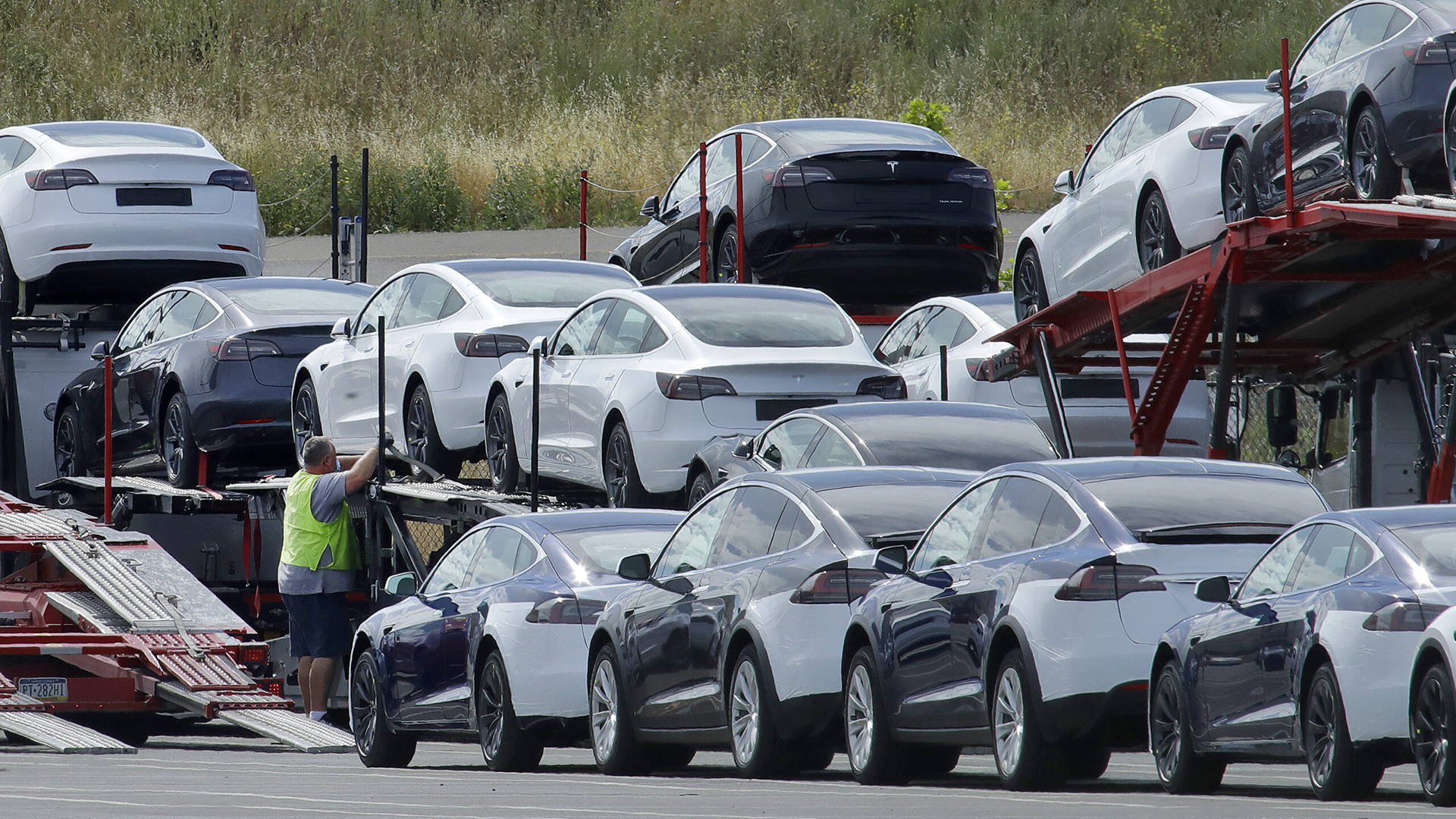 FILE - Tesla cars are loaded onto carriers at the Tesla electric car plant on May 13, 2020, in Fremont, Calif. Tesla is recalling nearly 363,000 vehicles with its “Full Self-Driving” system to fix problems with the way it behaves around intersections and following posted speed limits, the National Highway Traffic Safety Administration announced Thursday, Feb. 16, 2023. (AP Photo/Ben Margot, File)